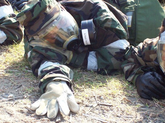 ANDREWS AIR FORCE BASE, Md. -- An Airman in full mission-oriented protective posture gear lays close to the ground during a alarm red ground attack in a mass casualty exercise here Sept. 9. (U.S. Air Force photo/Senior Airman Jessica Andrews)