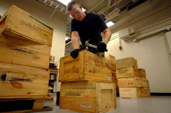 Staff Sgt. Sam Kunz, 437th Maintenance Squadron munitions systems craftsman hammers lids on wooden boxes containing countermeasure flares for  the C-17 in the Charleston AFB, S.C. munitions bay Sept. 11.  (U.S. Air Force photo/Airman 1st Class Nicholas Pilch) 
