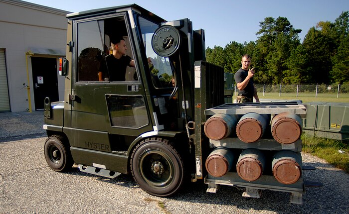 Senior Airmen David hardy and Brian Rheault move munitions casings that will be shipped the McChord AFB, Wash., at the Charleston AFB, S.C. munitions loading area Sept. 11.(U.S. Air Force photo/Airman 1st Class Nicholas Pilch) 

