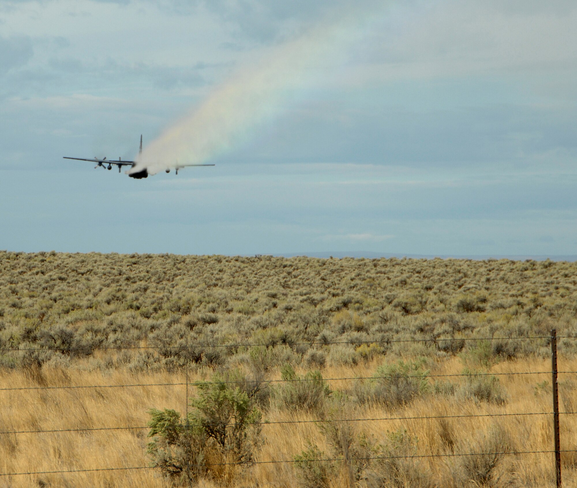 MOUNTAIN HOME AIR FORCE BASE, Idaho -- A specially modified C-130 Hercules aircraft conducts an herbicide aerial spray mission over the base’s Saylor Creek Range in 2007. Beginning Sept. 14 and lasting though Sept. 28, approximately 3,200 acres of Air Force land in Owyhee County will be sprayed with the herbicide Plateau® to reduce the growth of cheatgrass – an invasive, non-native grass that chokes out native vegetation and has contributed to recent catastrophic range fires. (U.S. Air Force photo/ Airman 1st Class Stephany Miller)