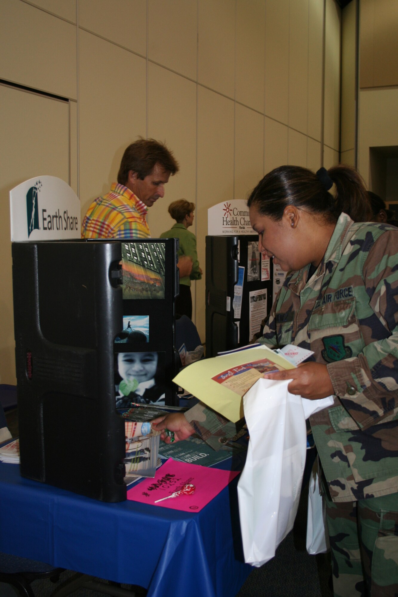 An Airman from Eglin Air Force Base visits the Earth Share charity booth during the 2007 Combined Federal Campaign  kick off event at the Emerald Coast Conference Center, 18 Sept. 2007. The CFC gives Military and federal employees a chace to help over 20,00 non-profit charities world wide. Donations will start being collected on Sept 24. (U.S. Air Force photo by Senior Airman Ali Flisek)