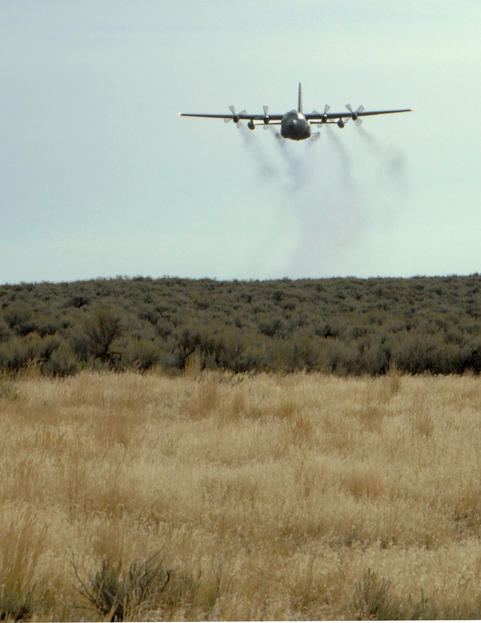 MOUNTAIN HOME AIR FORCE BASE, Idaho -- A specially modified C-130 Hercules aircraft conducts an herbicide aerial spray mission over the base’s Saylor Creek Range in 2007. Beginning Sept. 14 and lasting though Sept. 28, approximately 3,200 acres of Air Force land in Owyhee County will be sprayed with the herbicide Plateau® to reduce the growth of cheatgrass -- an invasive, non-native grass that chokes out native vegetation and has contributed to recent catastrophic range fires. (U.S. Air Force photo/ Airman 1st Class Stephany Miller)