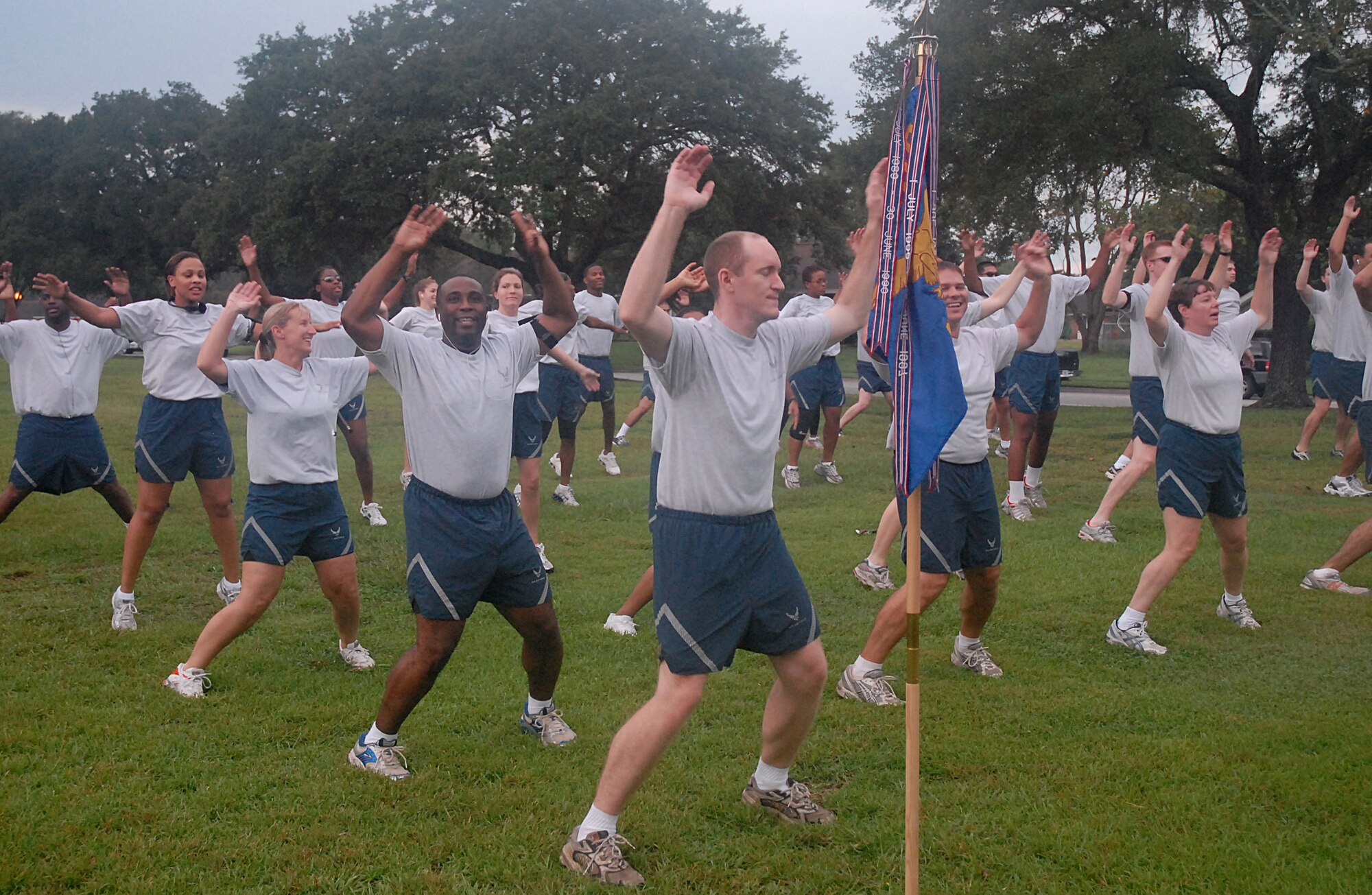 Members of the 437th Mission Support Squadron warm up for the 5K run Commander's Fitness Challenge by doing jumping jacks on base Sept. 14. (U.S. Air Force photo/Airman Melissa White)