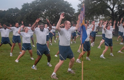 Members of the 437th Mission Support Squadron warm up for the 5K run Commander's Fitness Challenge by doing jumping jacks on base Sept. 14. (U.S. Air Force photo/Airman Melissa White)