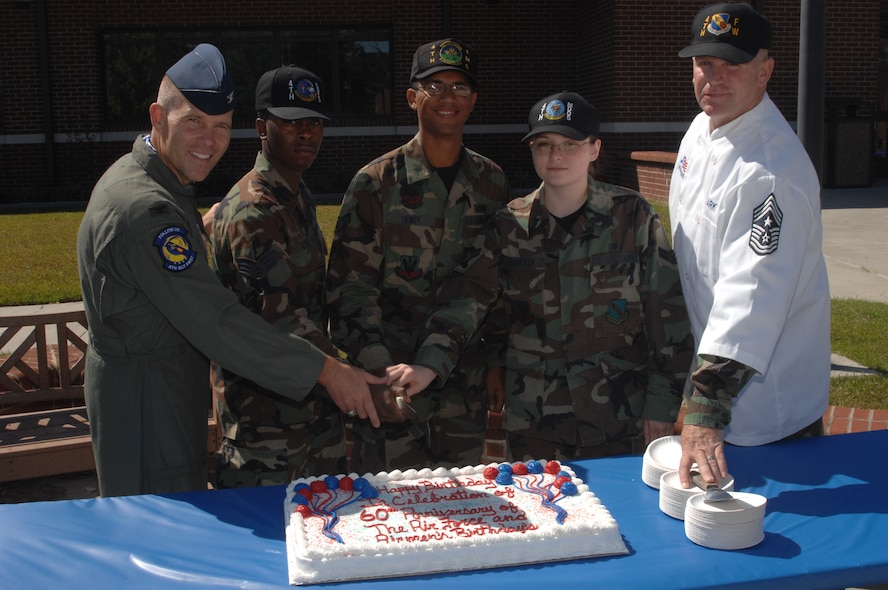 SEYMOUR JOHNSON AFB, N.C. - Colonel Steve Kwast, 4th Fighter Wing Commander, with Airman 1st Class Kwane Sledge, 4th Services Squadron, Airman 1st Class Dusty Henry, 4th Equipment Maintenance Squadron, Airman 1st Class Courtney Doherty, 4th Medical Group, and Chief Master Sergeant Layton Clark, 4th Fighter Wing Command Chief, kicking off the Air Force's birthday celebration with a cake cutting during the birthday lunch at the Dining Facility on September 18, 2007.  The Air Force is celebrating its 60th Birthday this year as a seperate military service. (US Air Force photo by Senior Airman Chad Trujillo)