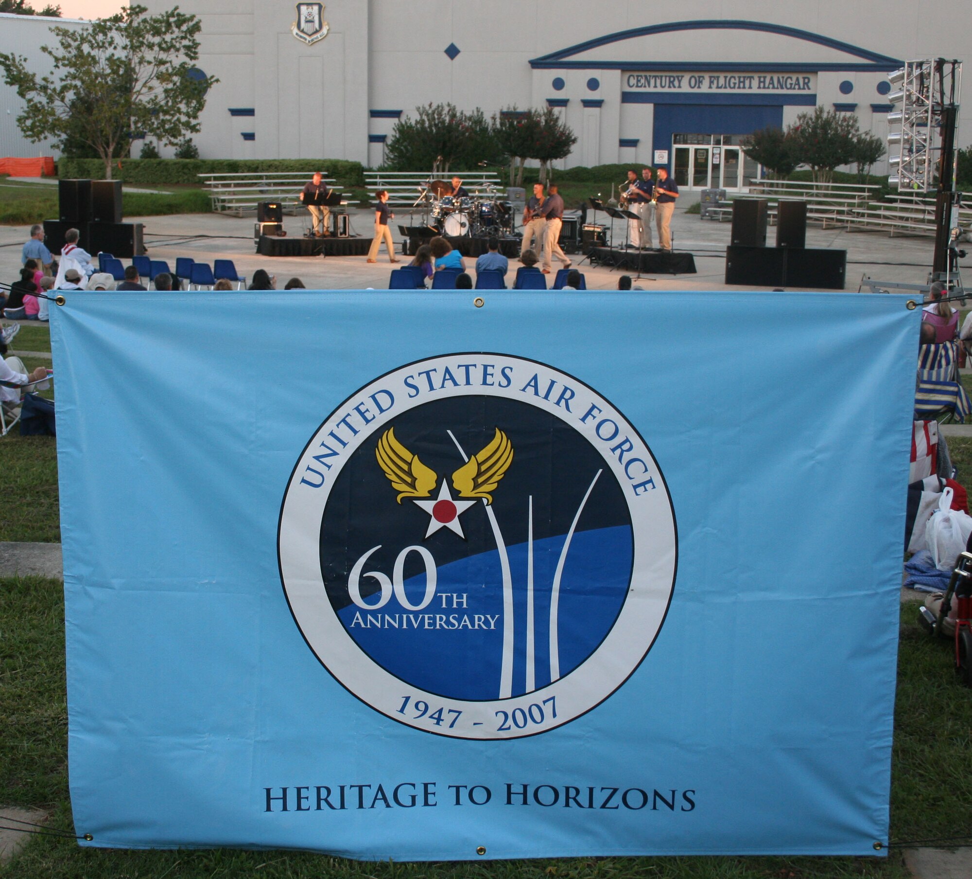 A banner at the Museum of Aviation in Warner Robins, Ga., reminds people of the Air Force’s heritage on Sept.18, 2007. In the background, members of the Band of the Air Force Reserve’s ensemble “High Flight” perform a musical salute to the birthday event. (U.S. Air Force photo/Steve French)

