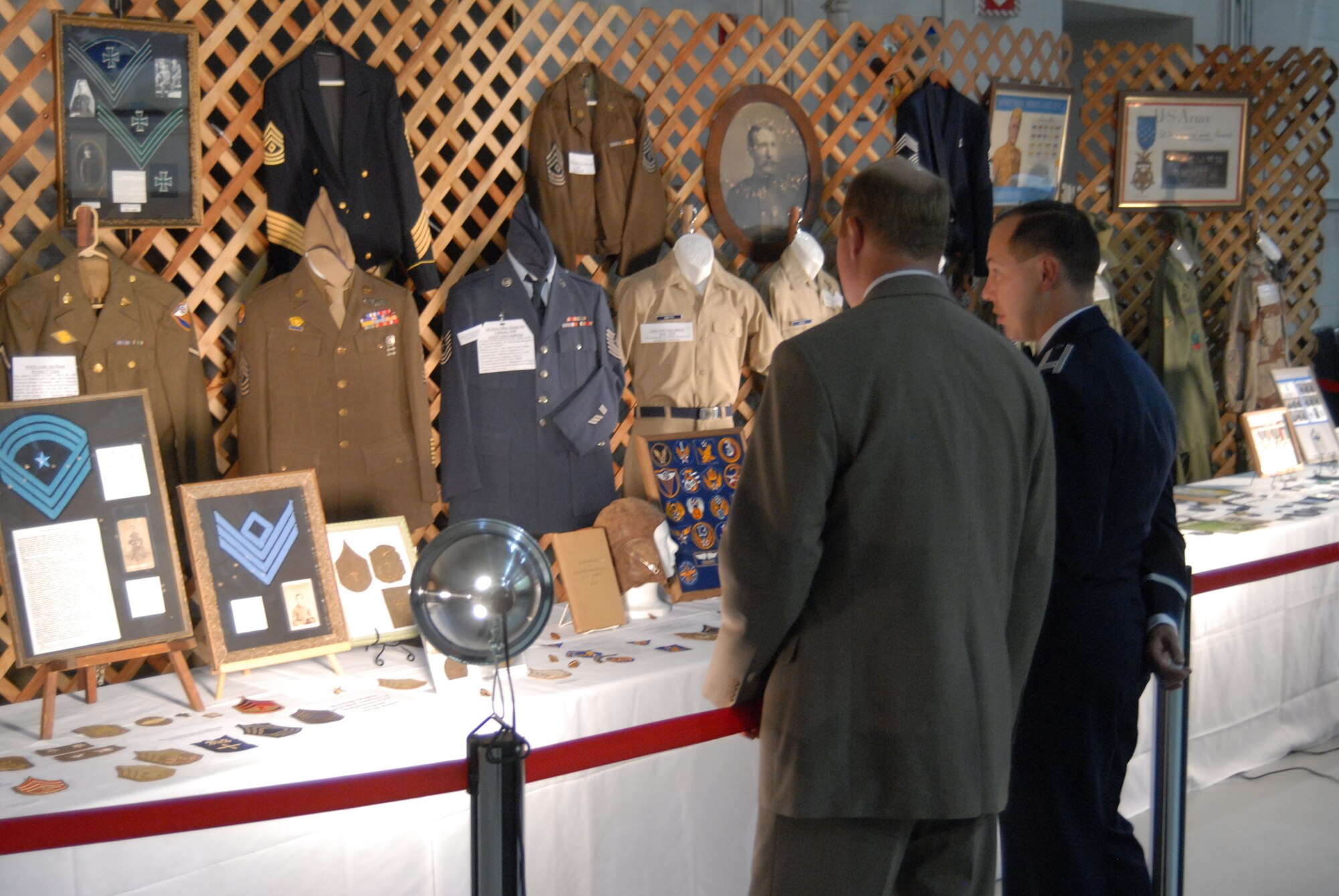 Two Air Force Ball attendees browse past the Air Force heritage display at the Malmstrom "Heritage to Horizons" 60th Anniversary Air Force Ball Sept. 15. The Air Force memoribilia spands from World War I to present, and is a personal collection of Senior Master Sgt. Jerry Hanes, 341st Missile Security Forces Squadron first sergeant. (U.S. Air Force photo/John Turner).