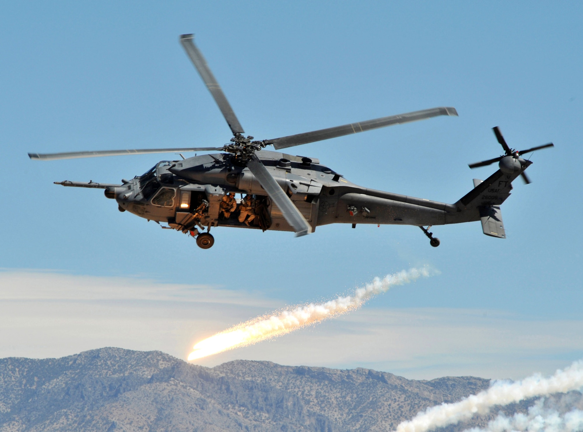 An HH-60 Pave Hawk assigned to Nellis Air Force Base, Nev., fires off chaff-flares while demonstrating evasive maneuvers during the firepower demonstration Sept. 14 at Nevada Test and Training Range. The demonstration gave the general public a close-up and realistic view into the Air Force's ability to perform its wartime mission. 
(U.S. Air Force photo/Airman 1st Class Brian Ybarbo) 
