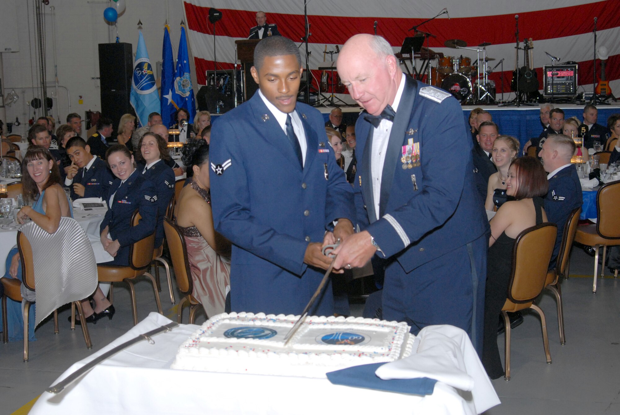 Airman 1st Class Ramon Wilson, 341st Missile Security Forces Squadron, and guest speaker Maj. Gen. Thomas Deppe, Air Force Space Command vice commander, cut the cake  at the Malmstrom "Heritage to Horizons" 60th Anniversary Air Force Ball Sept. 15. It is a long-standing Air Force tradition to have the most senior officer and youngest Airman perform the honors, signifying today and tomorrow's  Air Force leaders. (U.S. Air Force photo/John Turner).