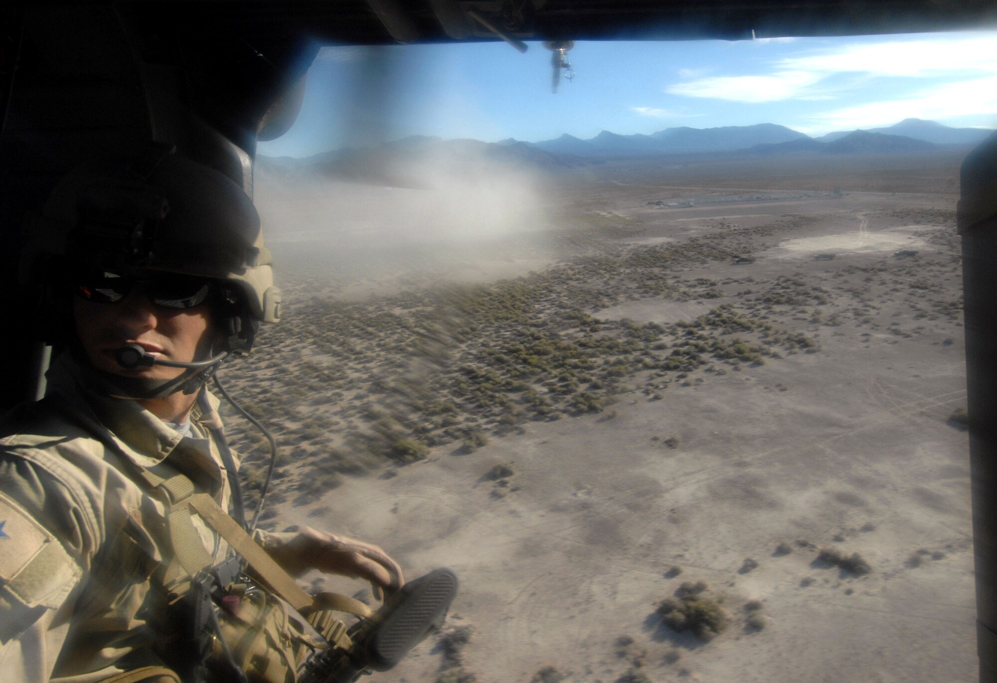 A pararescuemen from the 58th Rescue Squadron at Nellis Air Force Base, Nev., scans terrain during combat search and rescue operations during a firepower demonstration Sept. 14 on the Nevada Test and Training Range. The demonstration gave the general public a close-up and realistic view into the Air Force's ability to perform its wartime mission. (U.S. Air Force photo/Master Sgt. Kevin J. Gruenwald) 
