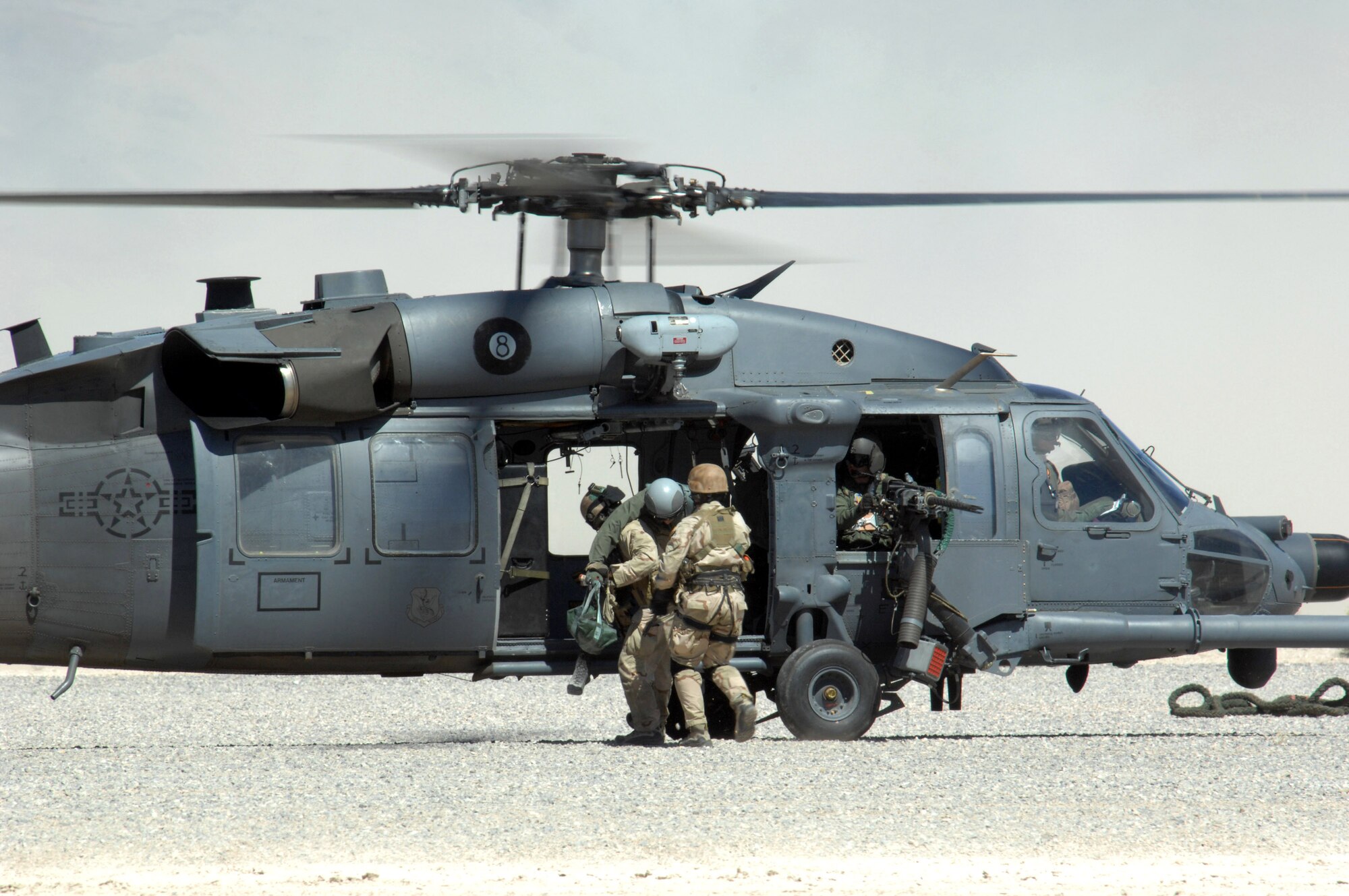 Pararescuemen from the 58th Rescue Squadron at Nellis Air Force Base, Nev., demonstrate combat search and rescue maneuvers while rescuing a downed pilot during a firepower demonstration Sept. 14 on the Nevada Test and Training Range. The demonstration gave the general public a close-up and realistic view into the Air Force's ability to perform its wartime mission. (U.S. Air Force photo/Staff Sgt. Kenny Kennemer) 
