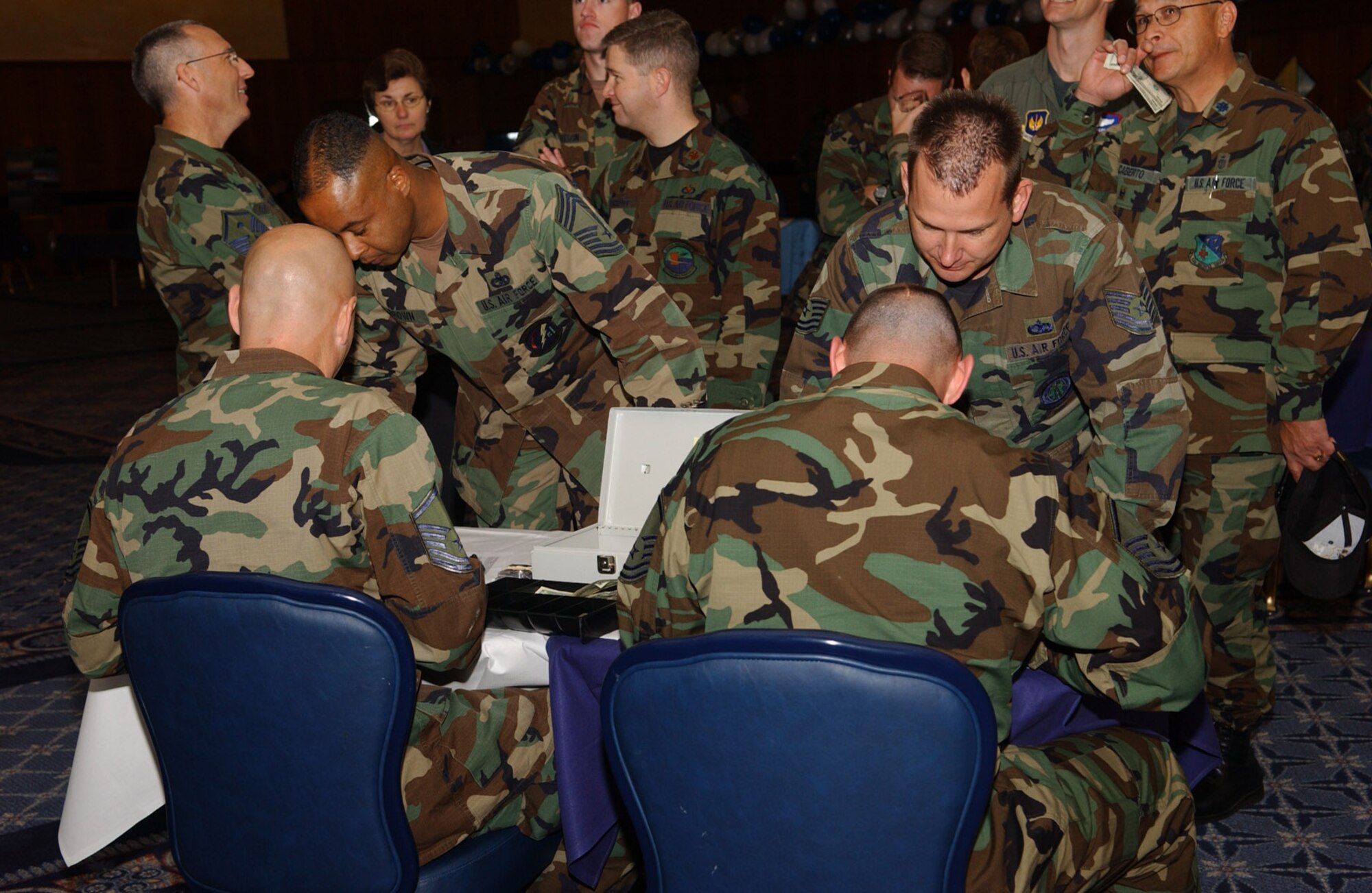 SPANGDAHLEM AIR BASE, Germany -- Sabers wait in line to pay for their Air Force 60th Anniversary coin during the Air Force Birthday Bash held at Club Eifel Sept. 18. The numbered anniversary coins were auctioned off by the Spangdahlem Air Base Air Force Ball planning committee. (U.S. Air Force photo/Airman 1st Class Allen Pollard) 
