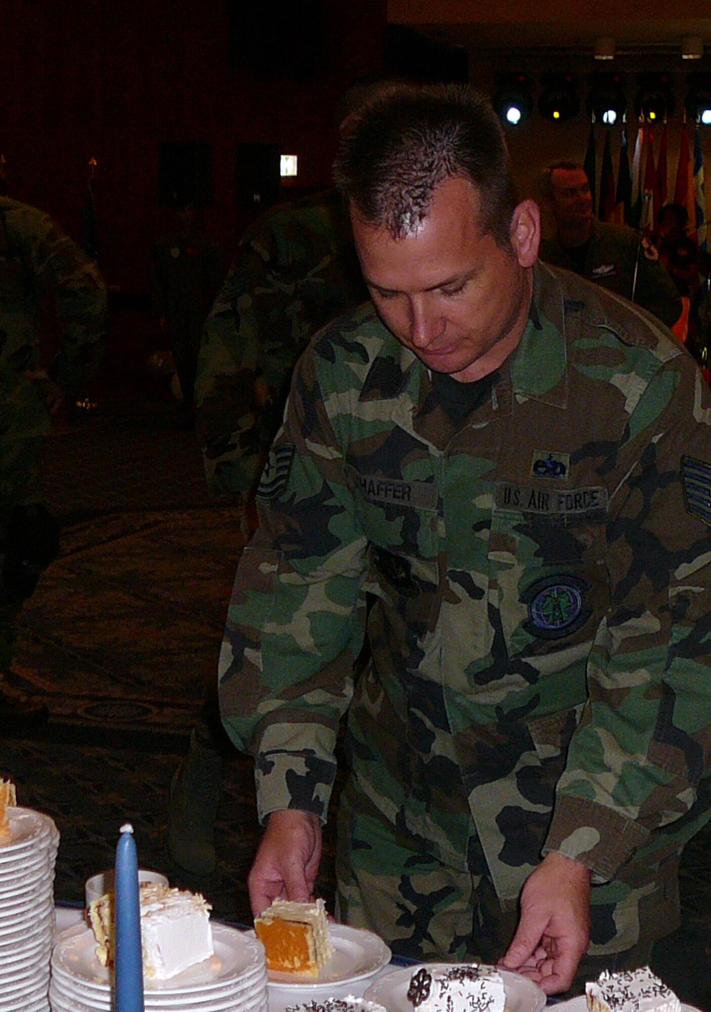 SPANGDAHLEM AIR BASE, Germany – Tech. Sgt. Adam Shaffer, 52nd Communications Squadron, takes a piece of Air Force 60th birthday cake during a celebration at Club Eifel Sept. 18. (U.S. Air Force photo/Tech. Sgt. Margie Quicanopalacios)