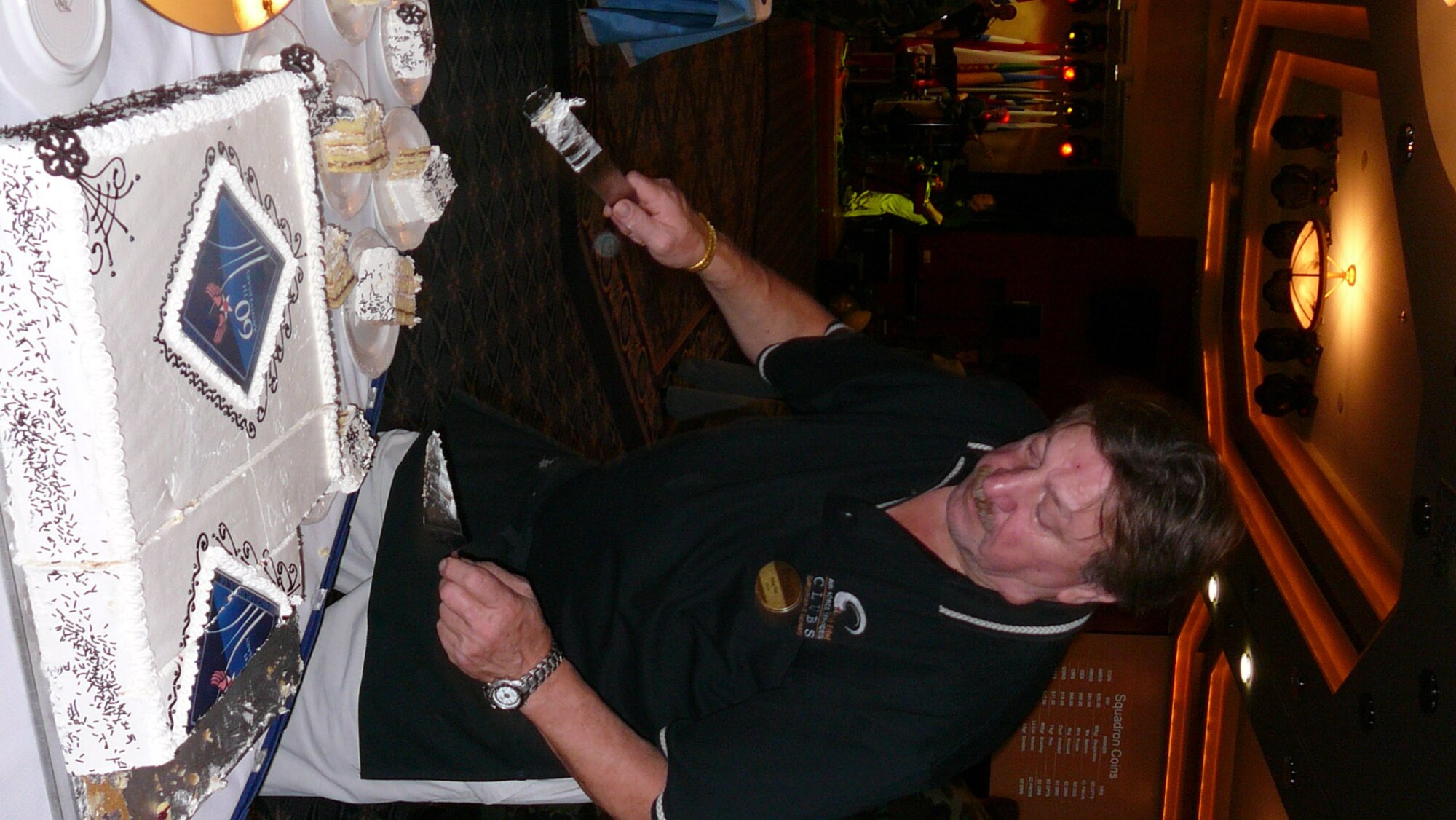 SPANGDAHLEM AIR BASE, Germany -- Peter Plei, Club Eifel, serves Sabers a slice of the Air Force 60th birthday cake during a celebration Sept. 18. (U.S. Air Force photo/Tech. Sgt. Margie Quicanopalacios)