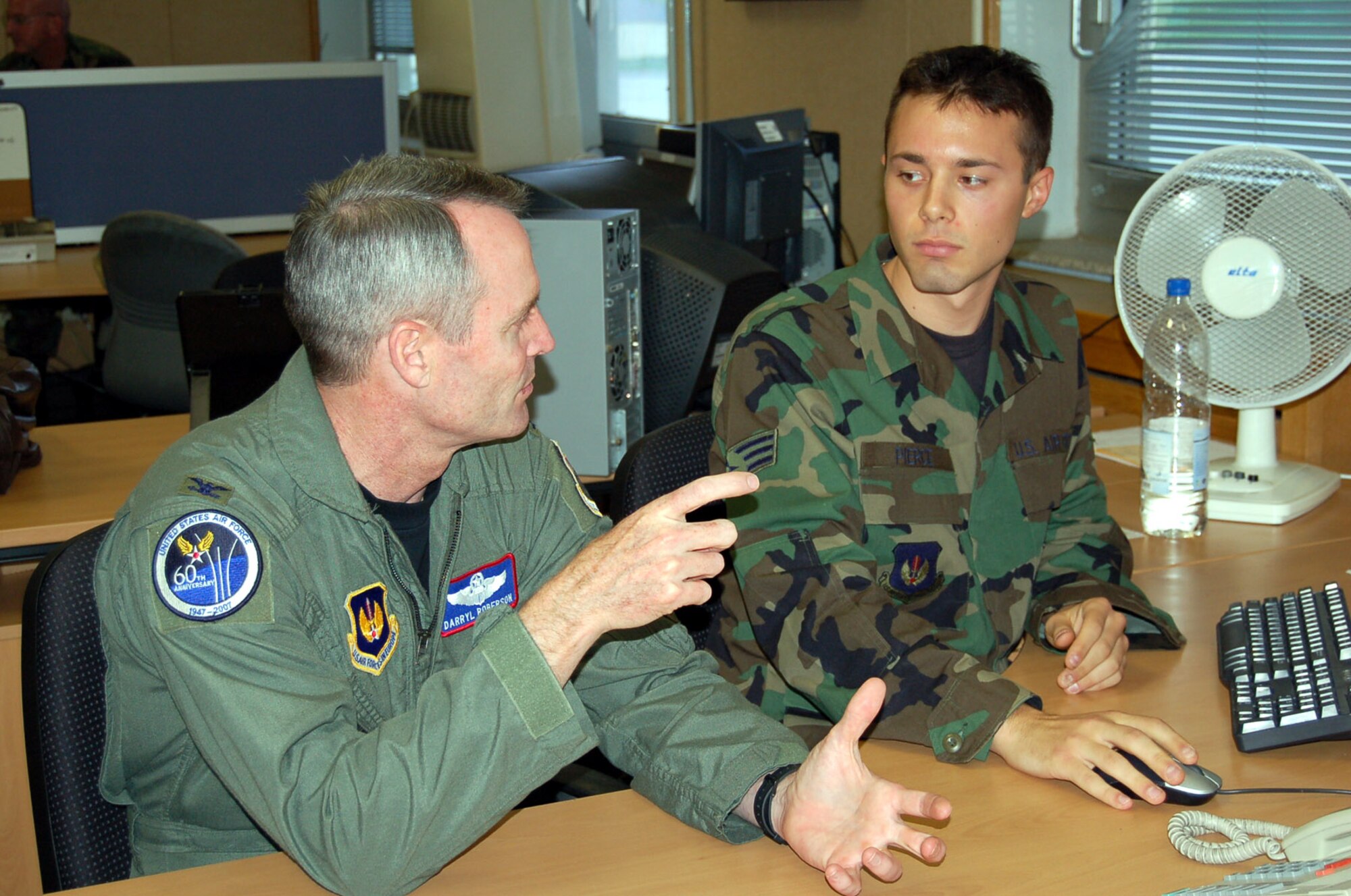 SPANGDAHLEM AIR BASE – Senior Airman Jarrett Pierce, 52nd Maintenance Operations Squadron, explains the aircraft engine management process to Col. Darryl Roberson, 52nd Fighter Wing commander, as he is shadowed by the commander Sept. 18. Airman Pierce an engine management section journeyman is a native of Middletown, Conn. According to his supervisor, Airman Pierce is a highly motivated subordinate whose impeccable drive is a great example for his peers. (U.S. Air Force photo/Staff Sgt. Tammie Moore)