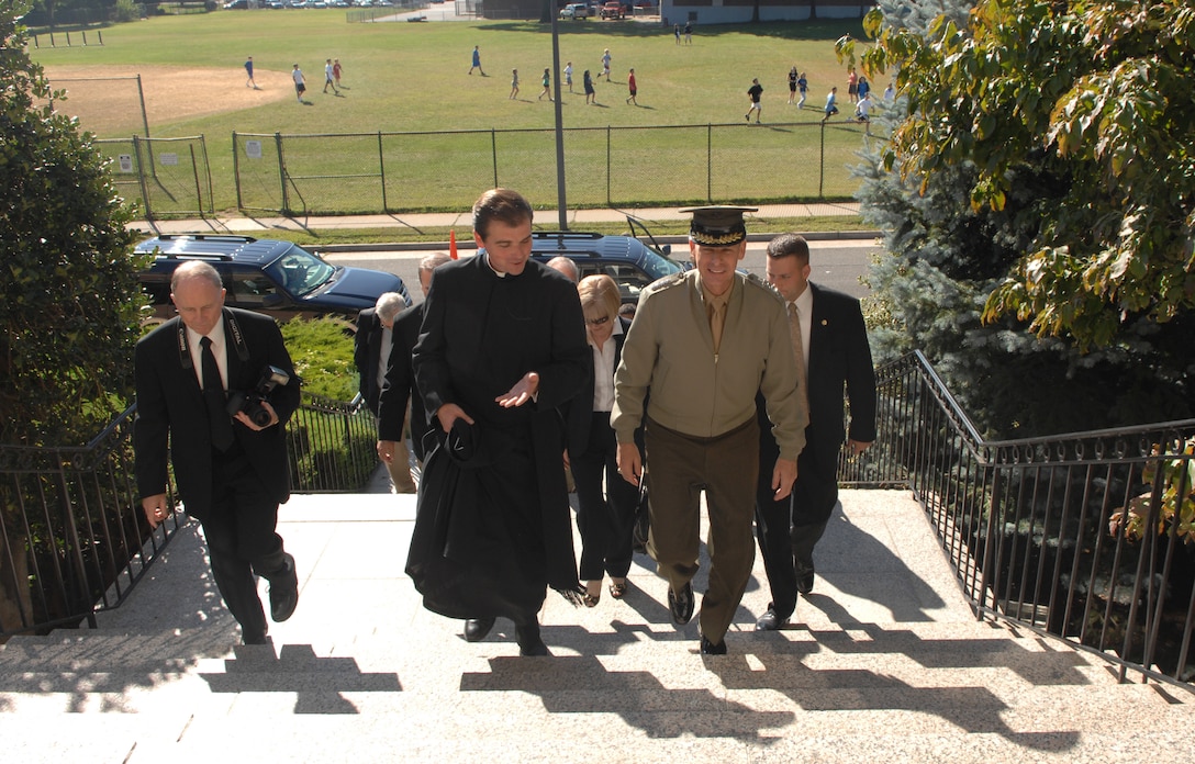 Rev. James C. Williams, president of Chaminade High School, escorts Marine Gen. Peter Pace into the administration building at the Mineola, N.Y. campus, Sept. 19, 2007. The chairman of the Joint Chiefs of Staff spoke to 1,700 students at the school. 