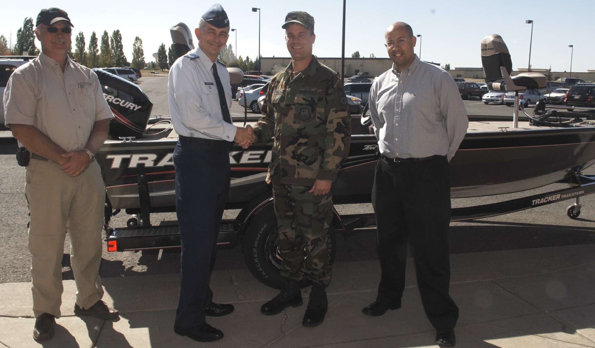 FAIRCHILD AIR FORCE BASE, Wash. -- Tech. Sgt. Rick Little, 141st Maintenance Squadron, was an AAFES Sweepstakes grand prize winner, and accepted his new Bass Pro Tracker Marine boat, motor, trailer, boat here Sept. 15. With the boat came a motor and trailer; the entire ensemble is valued at just under $18,000. Mike Manis from Action Marine Northwest; Col. Roger Watkins, 92nd Air Refueling Wing vice commander; and Matthew Beatty, Fairchild Exchange general manager, were on hand to congratulate Sergeant Little on his win. (U.S. Air Force photo/Senior Airman Chad Watkins)