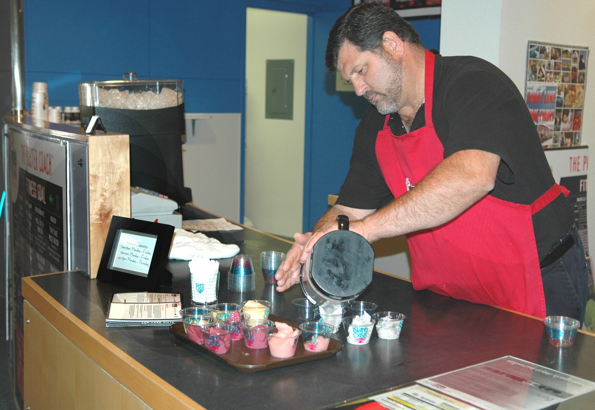 FAIRCHILD AIR FORCE BASE, Wash. – Dan Hill, a Power Blendz distributor, pours an ice-cold, blended beverage into small cups to hand out as samples during the grand opening of the Hydration Station juice bar in the fitness center Sept. 18. (U.S. Air Force photo / Airman 1st Class Kali L. Gradishar)