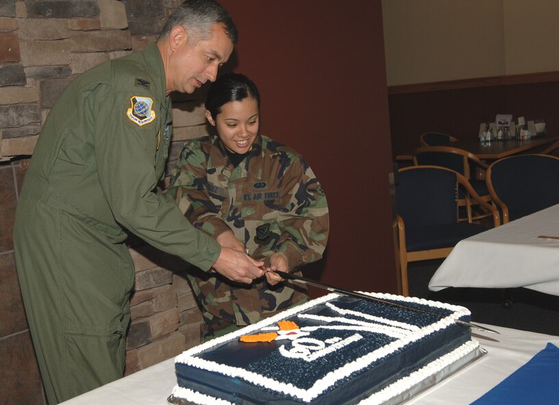 FAIRCHILD AIR FORCE BASE, Wash. -- During a celebration at Warrior Dining Facility commemorating the 60th Anniversary of the Air Force, Col. Roger Watkins, 92nd Air Refueling Wing commander, and Airman Amy Perez, 92nd Services Squadron chef, cut the Air Force birthday cake. (U.S. Air Force photo / Airman 1st Class Jocelyn Ford) 
