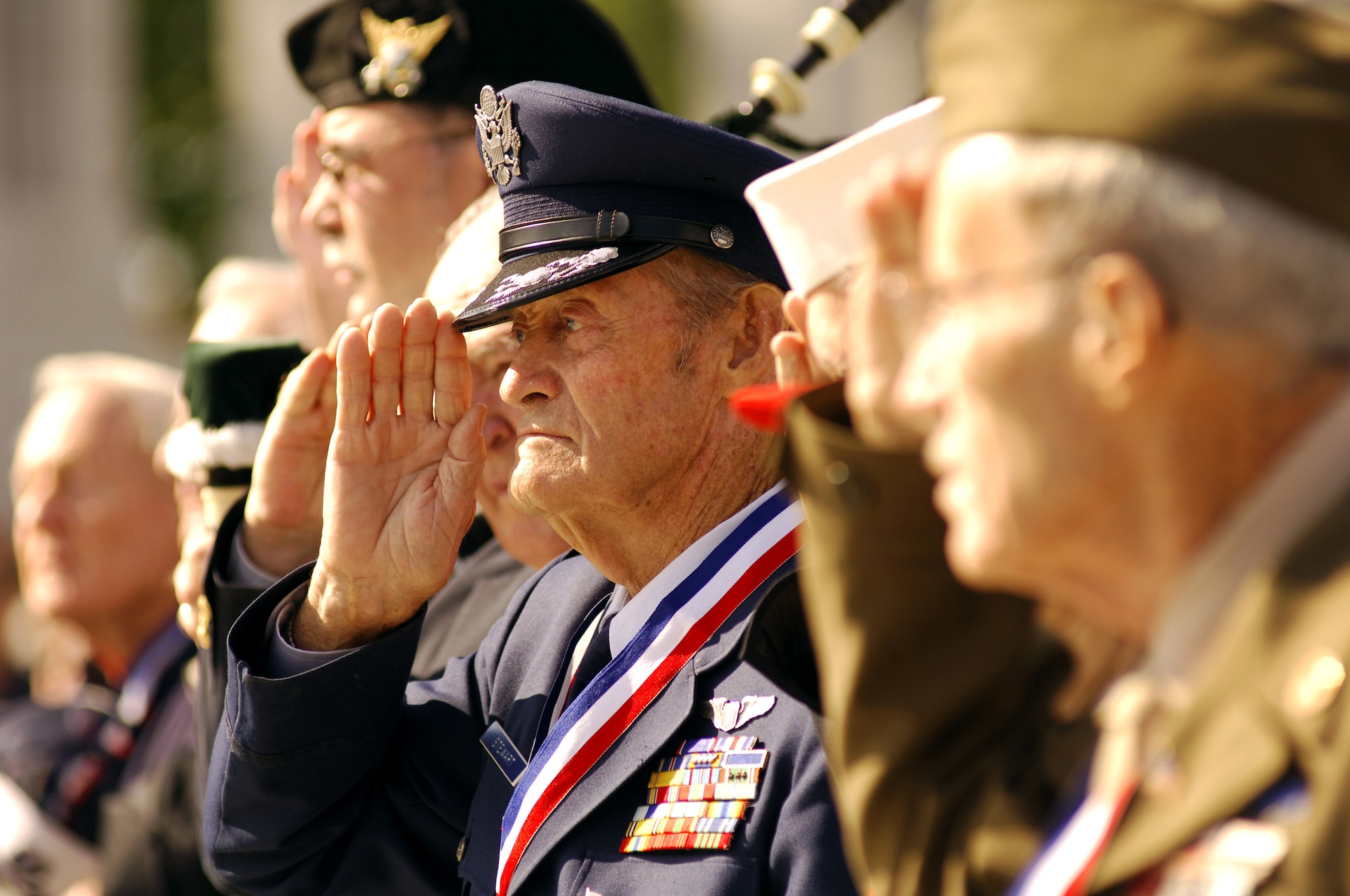 Retired Col. Walt Stewart stands and salutes the colors with fellow World War II veterans during a ceremony for Hero Flight 2007 at the National World War II Memorial in Washington, D.C., Sept. 15. Hero Flight is an all-volunteer program that sets up trips to allow as many World War II veterans as possible to visit the National World War II Memorial. (U.S. Air Force photo/Staff Sgt. Suzanne Day)
