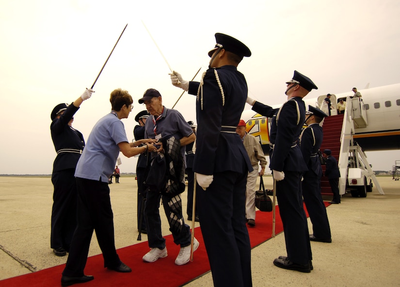 More than 120 World War II veterans participating in Hero Flight 2007 are greeted by the honor guard at Andrews Air Force Base, Md., Sept. 14. Hero Flight is an all-volunteer program that sets up trips to allow as many World War II veterans as possible to visit the National World War II Memorial. (U.S. Air Force photo/Staff Sgt. Suzanne Day)