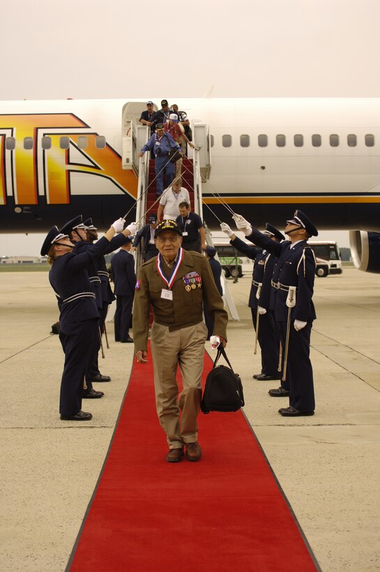 Ben Strohm, a World War II veteran, is greeted by Col. Kenneth Volmert, 316th Operations Group commander, and the Honor Guard at Andrews Air Force Base, Md., Sept. 14. Mr. Strohm is one of the 122 veterans participating in Hero Flight 2007. Hero Flight is a private organization that gives WWII Veterans the opportunity to visit the National WWII Memorial, located in Washington D.C., at no cost to the veteran. (US Air Force/SSgt Suzanne Day)