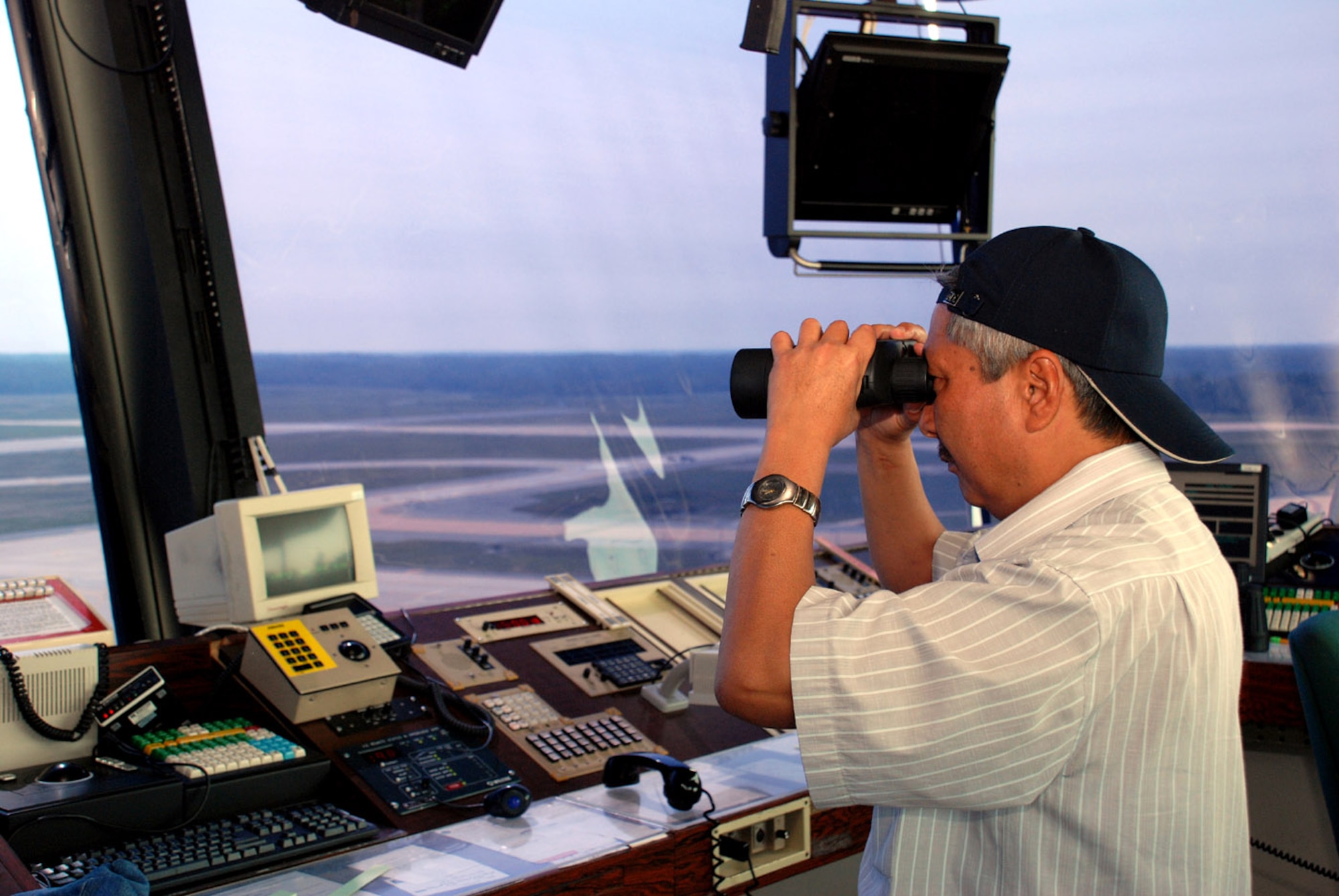 Akhmed Abdyramanov scans the flightline to get a sense of the airfield management operations Sept. 6 at Andrews Air Force Base, Md. Helicopters and fixed-wing aircraft share the Andrews AFB air space, which provides additional challenges for air traffic controllers. Mr. Abdyramanov is a a senior air traffic controller with Kyrgyz air navigation. The Kyrgyz controllers had the opportunity to participate in a U.S. orientation trip Sept. 3 to 17. The seven controllers visited a number of air traffic control facilities in the United States including Federal Aviation Administration facilities, Andrews AFB and Keesler AFB, Miss., home of the military air traffic control school. (U.S. Air Force photo/Senior Airman Alexy Saltekoff)