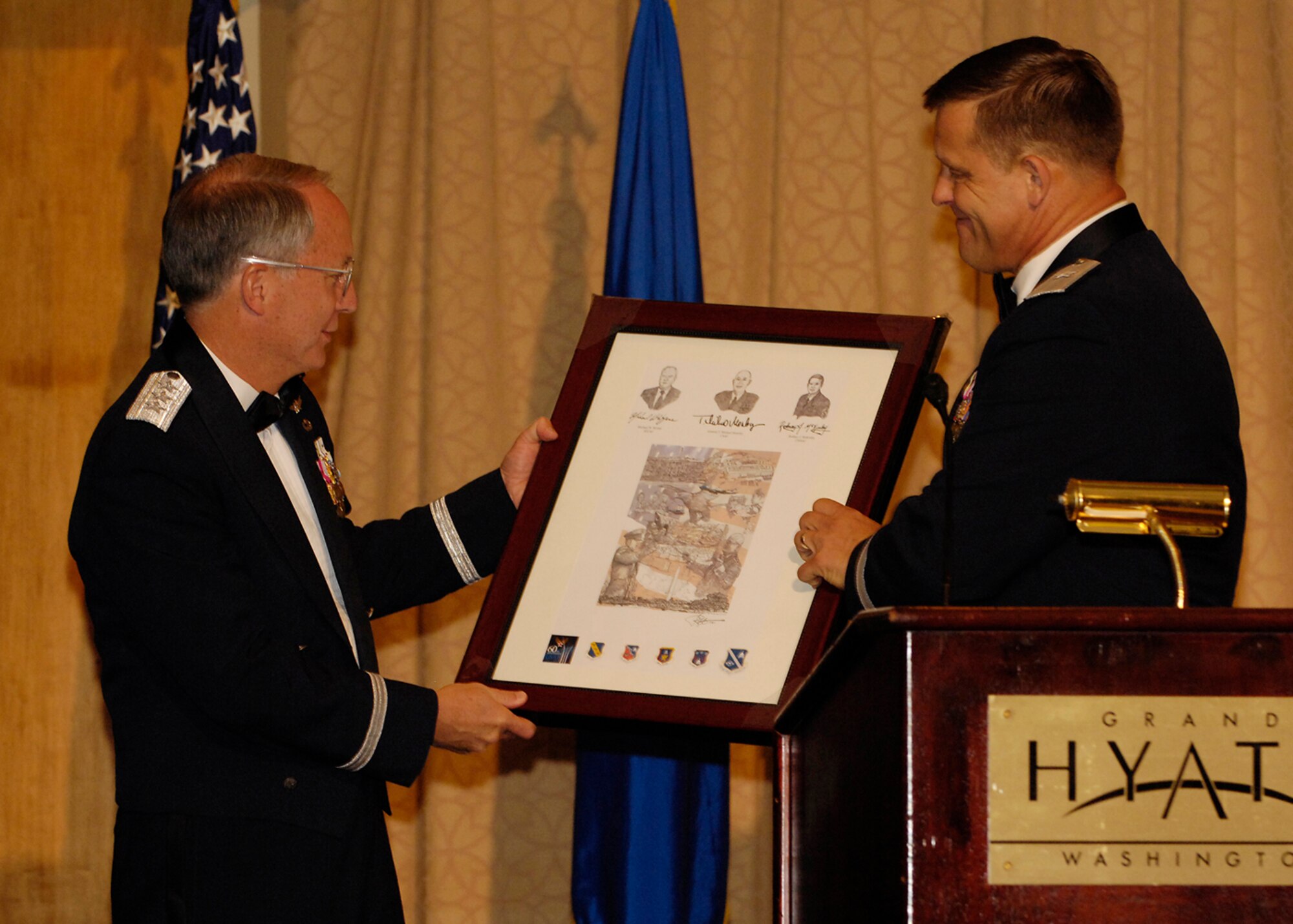 General Frank Gorenc, Air Force District of Washington commander, presents guest speaker Lt. Gen. Frank Klotz a lithograph during the Air Force Ball at the Grand Hyatt in Washington, D.C. Sept. 15.