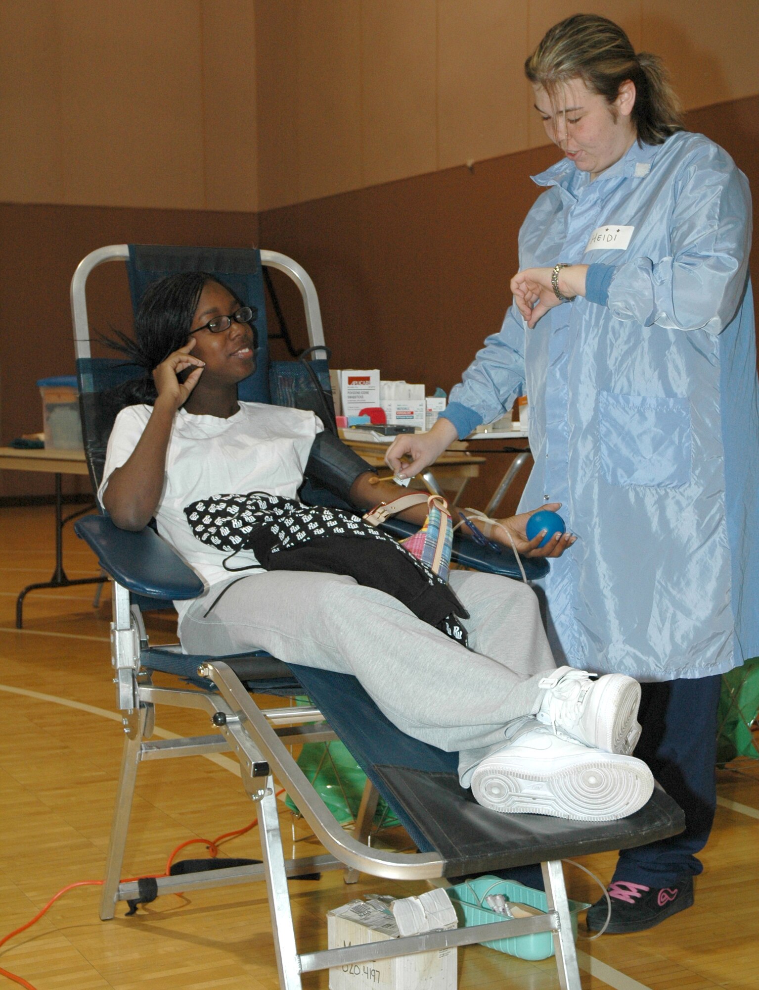 Heidi McCarther, American Red Cross phlebotomist, prepares Airman 1st Class Sonjanique Bennett, 12th Missile Squadron missile chef, to donate a pint of blood during the monthly blood drive held in the lower gym of the fitness center at Malmstrom Air Force Base Sept. 18. According to the American Red Cross, a pint of blood can potentially save up to three lives. (U.S. Air Force photo/Airman 1st Class Dillon White)