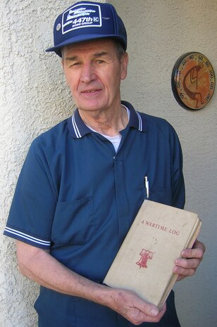 Carroll Knutson, an 83-year-old former prisoner of war,
native of Santa Monica, Calif., present chairman of the 7-11 chapter
American Ex-prisoners of War Veterans History Project archive and a
member of the POW/MIA ceremony team here at Nellis Air Force Base.  Mr. Knutson is shown holding a wartime log that he traded his cigarette rations for.  Mr. Knutson was captured after his B-17 was hit with ground fire over Germany in 1944.(Courtesy Photo)
