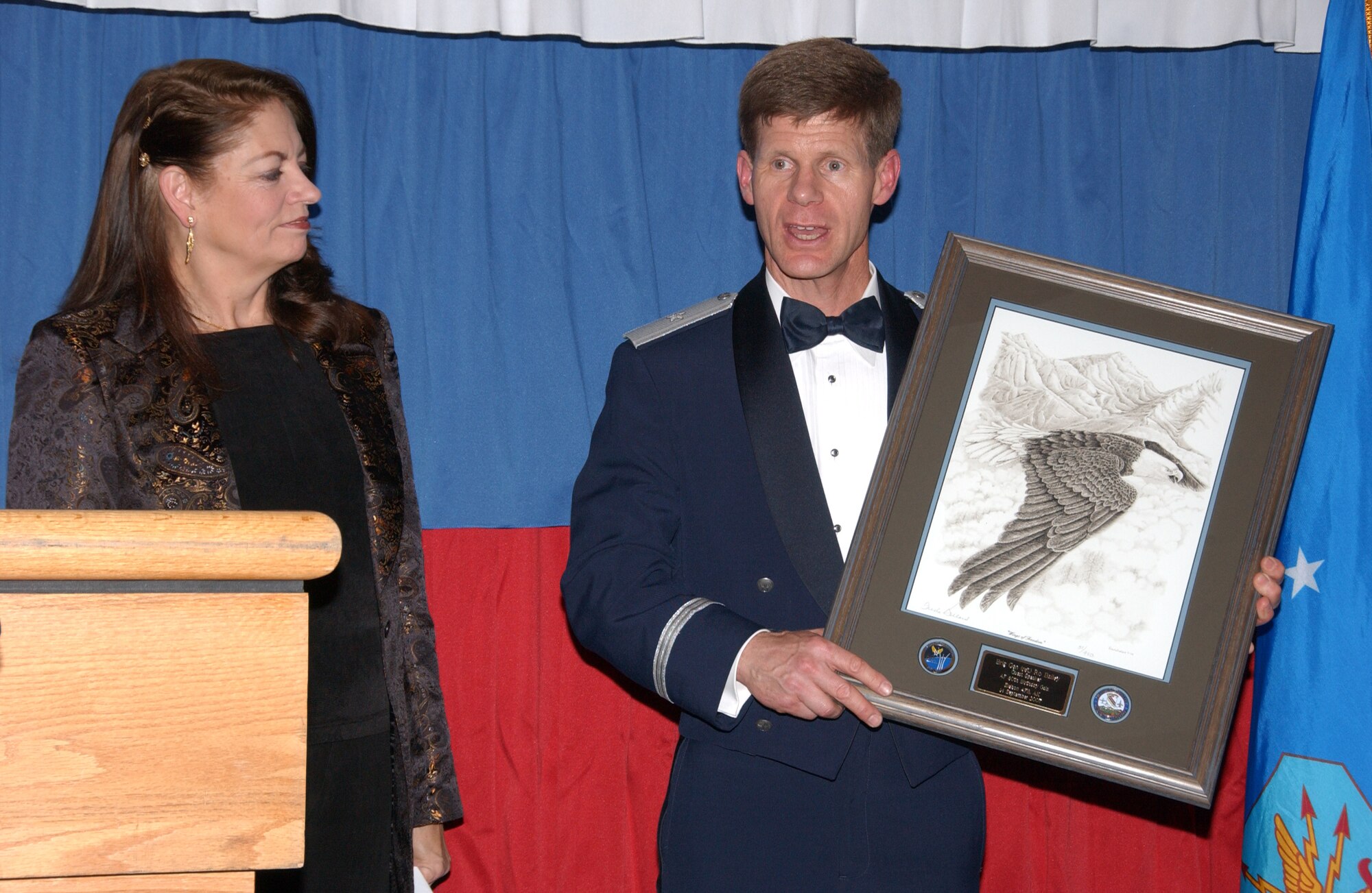 EIELSON AIR FORCE BASE, Alaska --  The local Interior civilian community supported the Air Force and the Iceman Team at the Gala. After her speech, retired Air Force Brig. Gen. Ro Bailey, University of Alaska Fairbanks vice chancellor, received a memento as a gesture of thanks from Brig. Gen. Mark Graper, 354th Fighter Wing commander.  (U.S. Air Force photo by Airman 1st Class Jonathan Snyder)