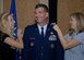 LANGLEY AIR FORCE BASE -- Caroline Barrett and Elizabeth Wencesalo pin stars on the shoulders of their father, Brig. Gen. Mark Barrett, 1st Fighter Wing commander, during his frocking ceremony Sept. 17 at the Bayside Enlisted Club. (U.S. Air Force photo/Senior Airman Tabitha Kuykendall)