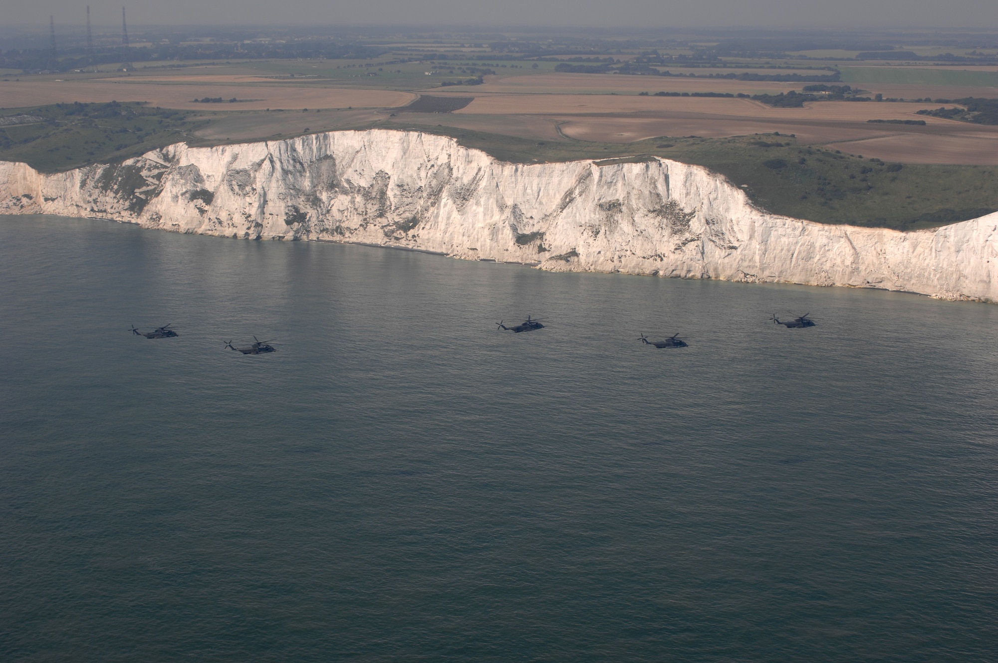 Making an historic pass by the chalky White Cliffs of Dover, England, five MH-53M Pave Low IV helicopters from the 21st Special Operations Squadron stationed at RAF Mildenhall, continue their final flight, Sept. 13, 2007.
(U.S. Air Force Photo by Tech. Sgt. Tracy L. DeMarco)

