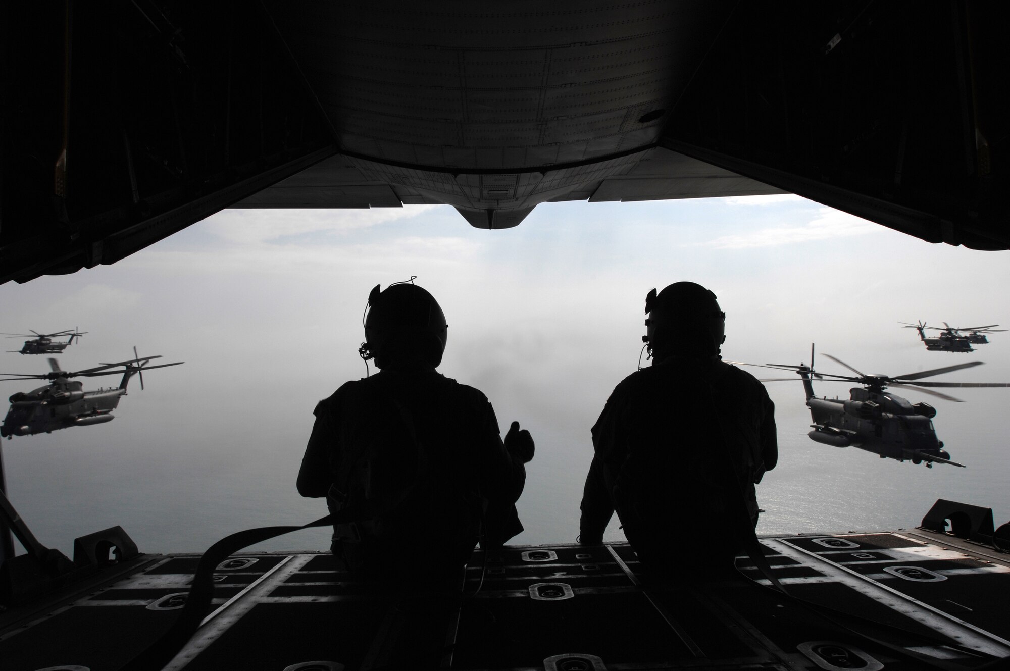 A grand stage was set for the last refueling of the 21st Special Operations Squadron MH-53M Pave Low IV helicopters stationed at RAF Mildenhall, by the 67th Special Operations Squadron MC-130P Combat Shadow during the Pave Low's final flight, Sept. 13, 2007. The two loadmasters use hand signals to communicate with the helicopter pilots approaching to receive fuel.
(U.S. Air Force Photo by Tech. Sgt. Tracy L. DeMarco)
