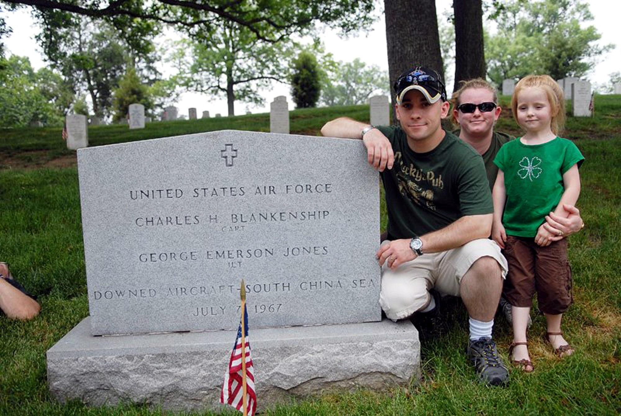 Staff Sgt. Gary Ritter, along with wife, Kristina, and daughter, Cheyenne, visit the gravesite of 1st Lt. George Jones of Aberdeen, Miss., May 28 at Arlington National Cemetery. Sergeant Ritter made the journey to Arlington to meet with the family of Lieutenant Jones, and to give them the POW/MIA bracelet baring the Lieutenant's name that he had kept for 19 years. He gave the bracelet to the youngest daughter of Lieutenant Jones on Memorial Day in honor of his memory. Sergeant Ritter is a combat arms instructor at the Expeditionary Center at Fort Dix, N.J. (U.S. Air Force photo/Christopher Duggan) 