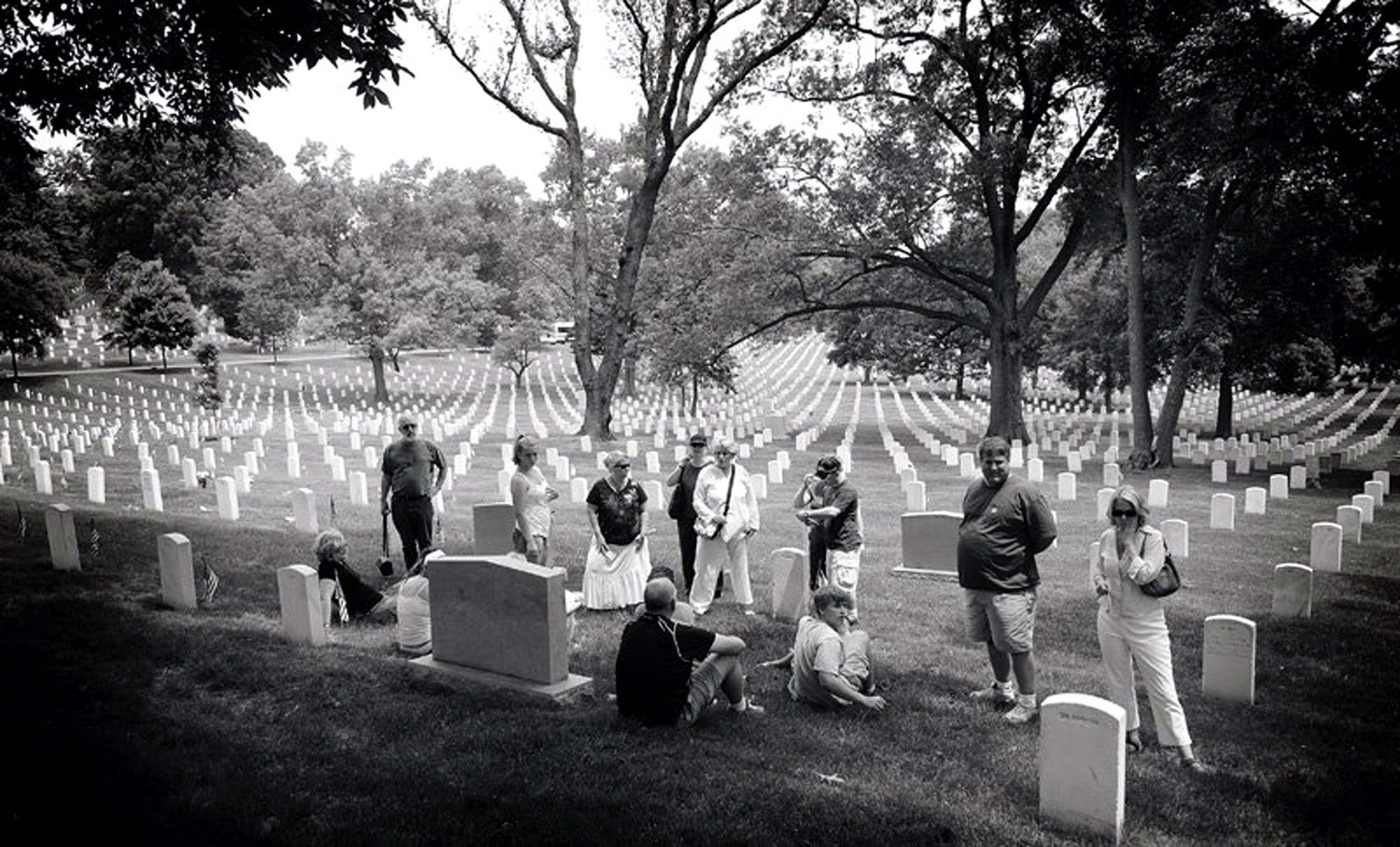 Familiy members of 1st Lt. George Jones gather at his burial site for a 10-year reunion May 28 at Arlington National Cemetery in Washington. Formerly missing in action, Lieutenant Jones crashed July 7, 1967, in the South China Sea. His remains were returned to his family and interred in 1997. Staff Sgt. Gary Ritter joined the family as a special guest. Sergeant Ritter had worn a POW/MIA bracelet with Lieutenant Jones' name on it for 19 years. Sergeant Ritter is a combat arms instructor at the Expeditionary Center at Fort Dix, N.J. (U.S. Air Force photo/Christopher Duggan) 