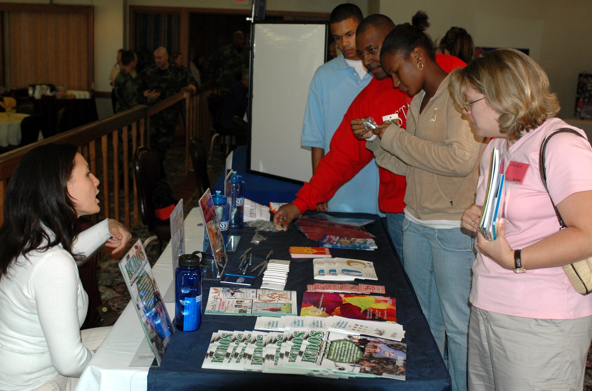 Spouses of deployed Team Travis members, gather around the 60th Services Squadron's table during the Deployed Spouses' dinner Sept. 18. The dinner informs deployed members' spouses about base and local resources available to them and allows them to socialize with other spouses in a social setting. (U.S. Air Force photo/Staff Sgt. Matthew McGovern)