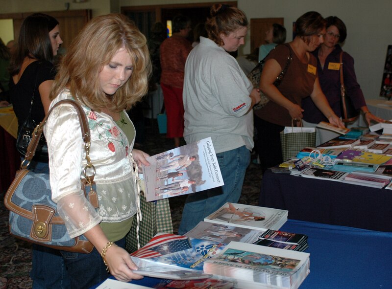 Tammie Potter, spouse of Capt. Thomas Potter, deployed from the 349th Component Maintenance Squadron, gathers information from the Airmen and Family Readiness table during the Deployed Spouses' dinner Sept. 18. The dinner informs deployed members' spouses about base and local resources available to them and allows them to socialize with other spouses in a social setting. (U.S. Air Force photo/Staff Sgt. Matthew McGovern)