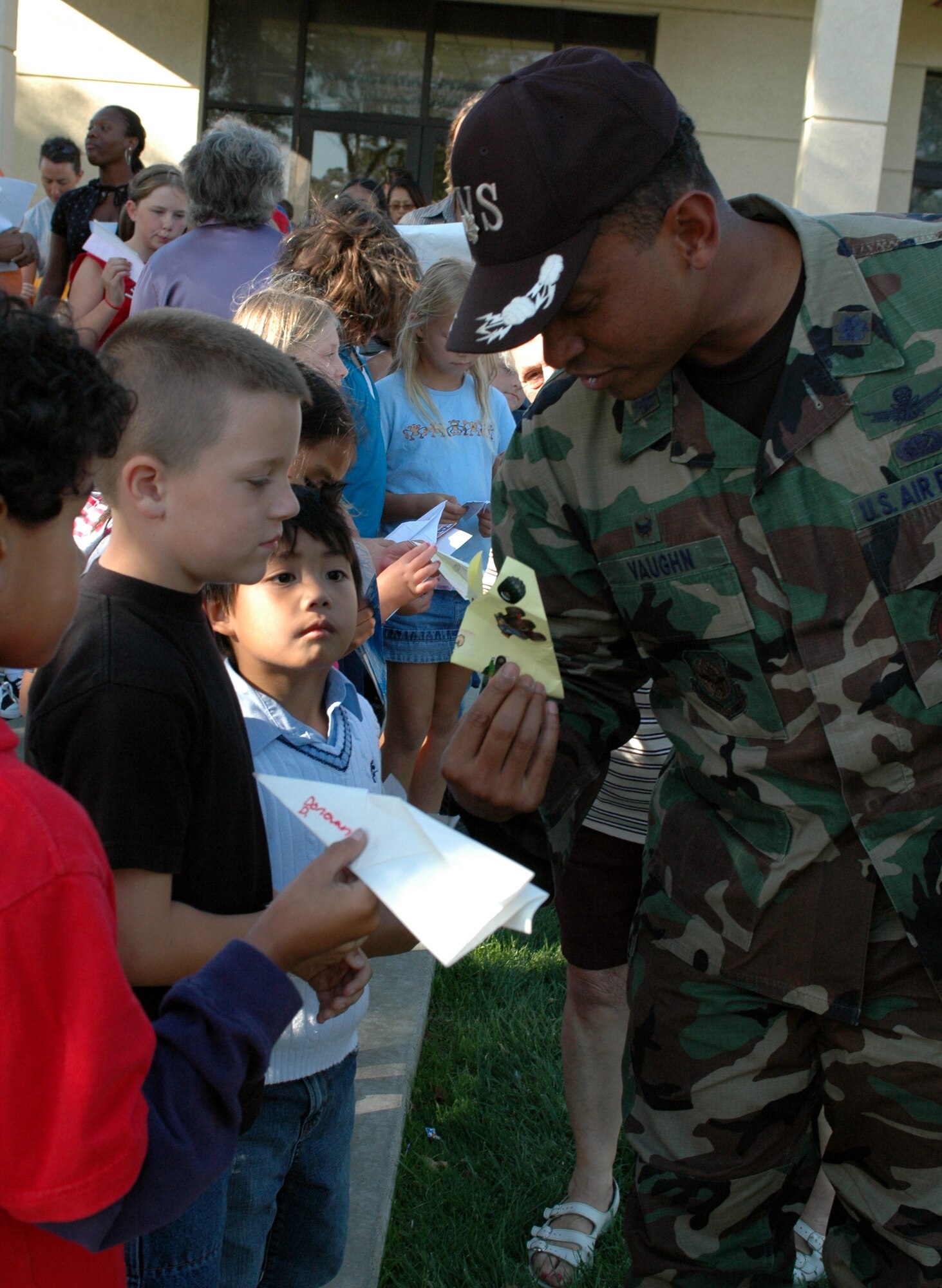 Lt. Col. Oscar Vaughn, 60th Services Squadron commander, judges a paper airplane during the Mitchell Memorial Library's "Great Paper Airplane" contest Sept. 18. The contest, open to all ages, was part of the 60th Air Force Birthday Celebration. (U.S. Air Force photo/Staff Sgt. Matthew McGovern)
