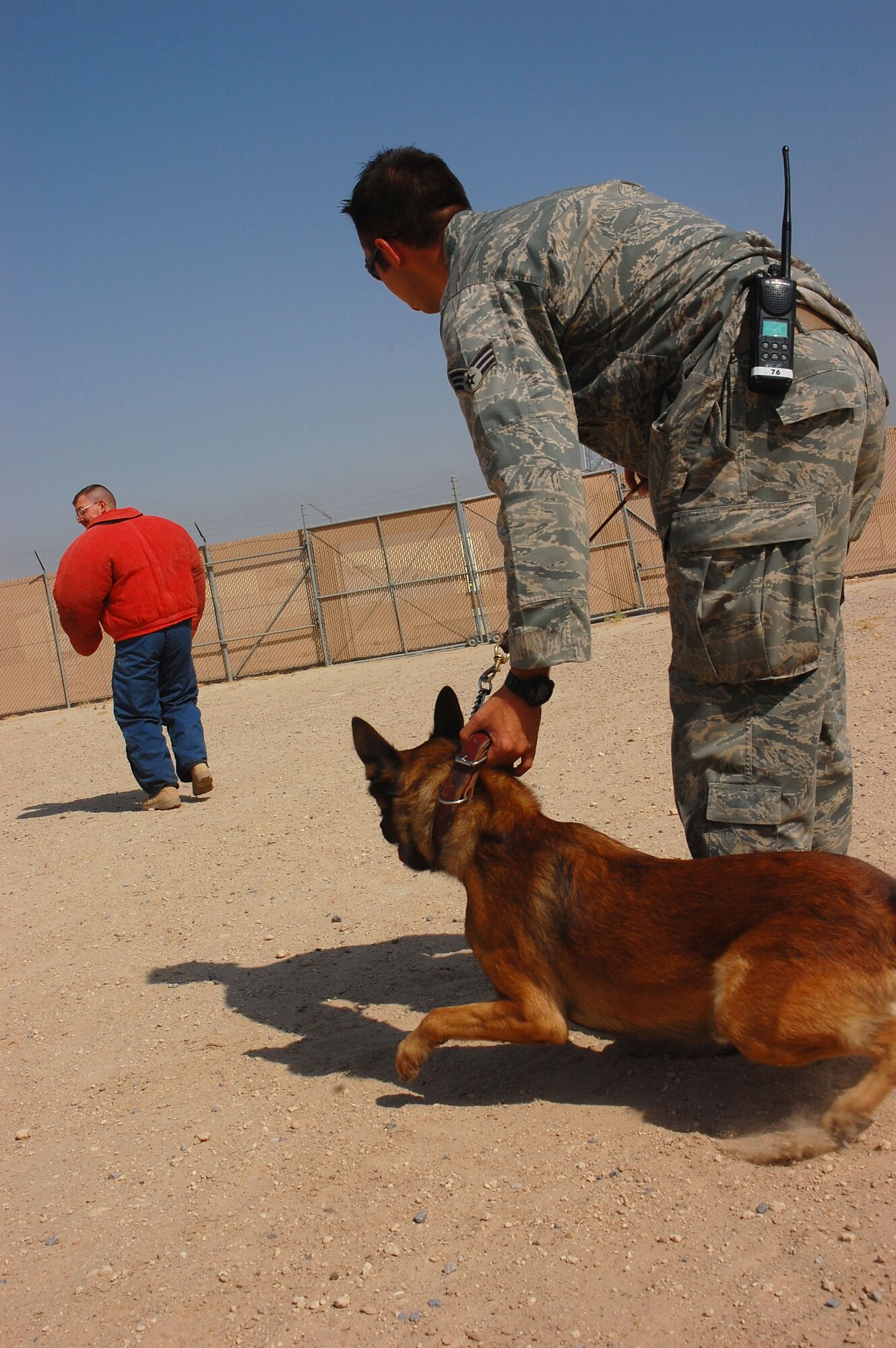 Senior Airman Justin Gatti, 386th Expeditionary Security Forces Squadron military working dog handler, prepares to release his partner, Axel, 386th ESFS Military Working Dog, to attack a decoy during aggression training Sept. 19, here. The military working dogs are trained several times a week to keep their skills sharp. (U.S. Air Force photo by Staff Sgt. Tia Schroeder)
