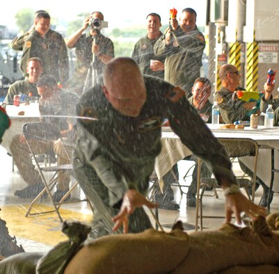 Colonel Reuben Knox, commander of the 758th Airlift Squadron, gets soaked as he runs through the obstacle course on his way to the grog bowl. (AF photo by Senior Airman Tamara Cario)