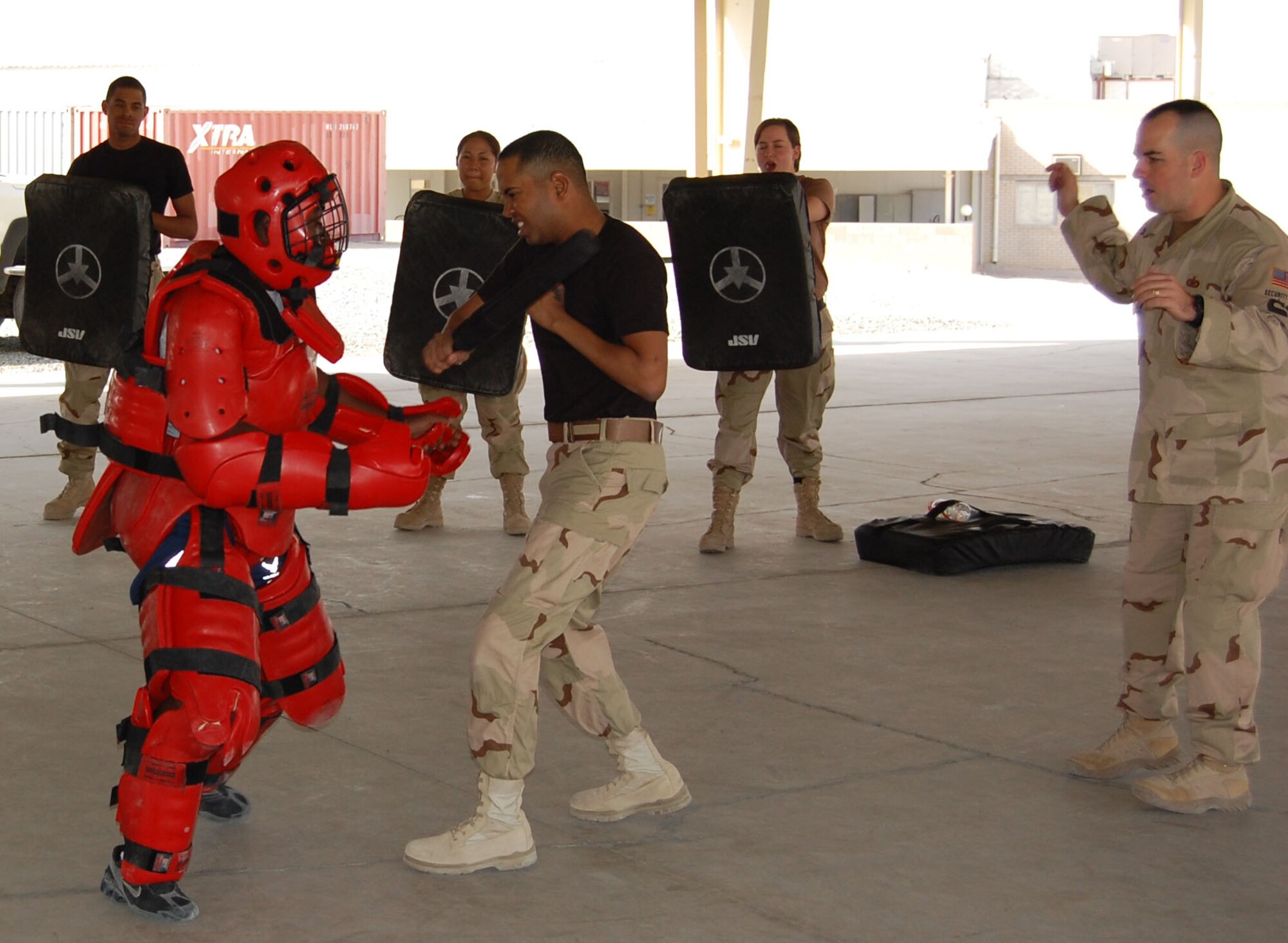 Airman 1st Class Andrew Jattan, 386th Expeditionary Security Forces Squadron force protection Airman, backpedals while striking the aggressor during baton training Sept. 20 in the Rock's pavilion. Baton training is required for security forces and force protection Airmen alike. (Photo by Air Force Staff Sgt. Phillip Butterfield)