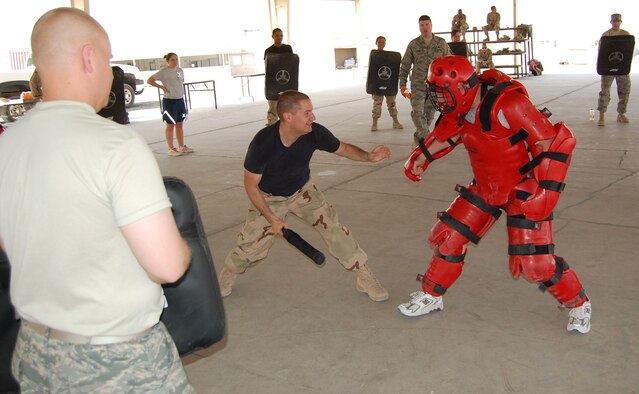 Senior Airman Ben Agent, 386th Expeditionary Security Forces Squadron force protection Airman, fights the aggressor during baton training Sept. 20 in the Rock's pavilion. Baton training is a two day course designed to give Airman confidence in the use of the collapsible weapon. (Photo by Air Force Staff Sgt. Phillip Butterfield)