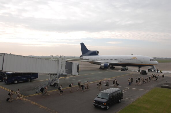 About 100 RAF Mildenhall Airmen are escorted from the passenger terminal to board an Air Mobility Command aircraft that will fly them to various deployment locations, Sept. 14, 2007. (U.S. Air Force photo by Tech. Sgt. Tracy L. DeMarco)
