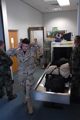 Embarking on his first deployment, Airman 1st Class Matthew Hutchison, 100th Services Squadron, clears the metal detector and enters the passenger holding area at RAF Mildenhall Sept. 14, 2007. "Excited? So-so; I'm not sure what's going to happen," he said. (U.S. Air Force photo by Tech. Sgt. Tracy L. DeMarco)

