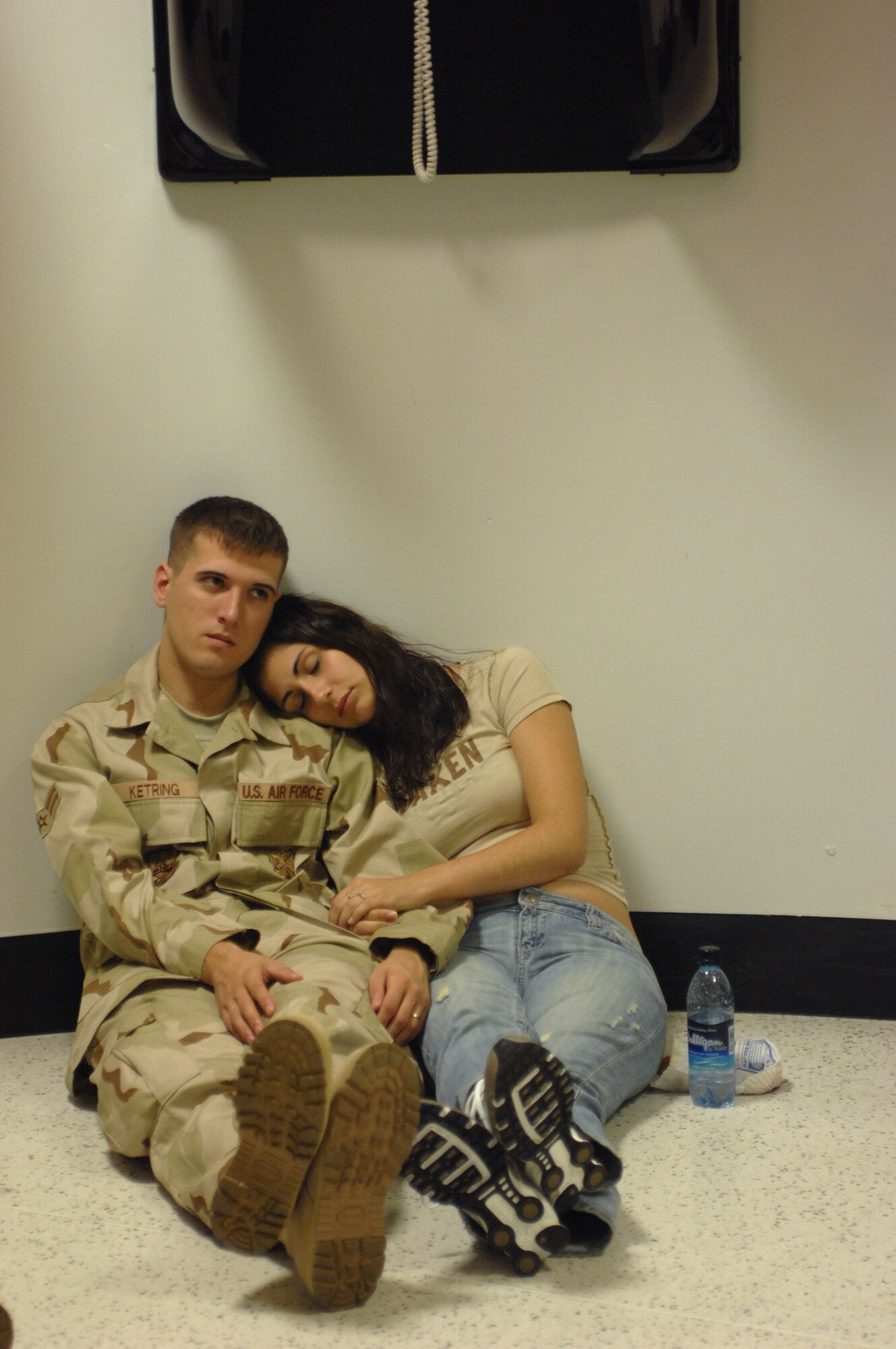 Airman 1st Class Tylor Ketring, 100th Civil Engineer Squadron firefighter, relaxes with his wife, Christine Mellor, while waiting for his deployment flight, Sept. 14, 2007. This is Airman Ketring's first deployment. "I'm worried, but I know firefighters don't have to go off base, so I know he'll be OK," said Ms. Mellor.  (U.S. Air Force photo by Tech. Sgt. Tracy L. DeMarco)
