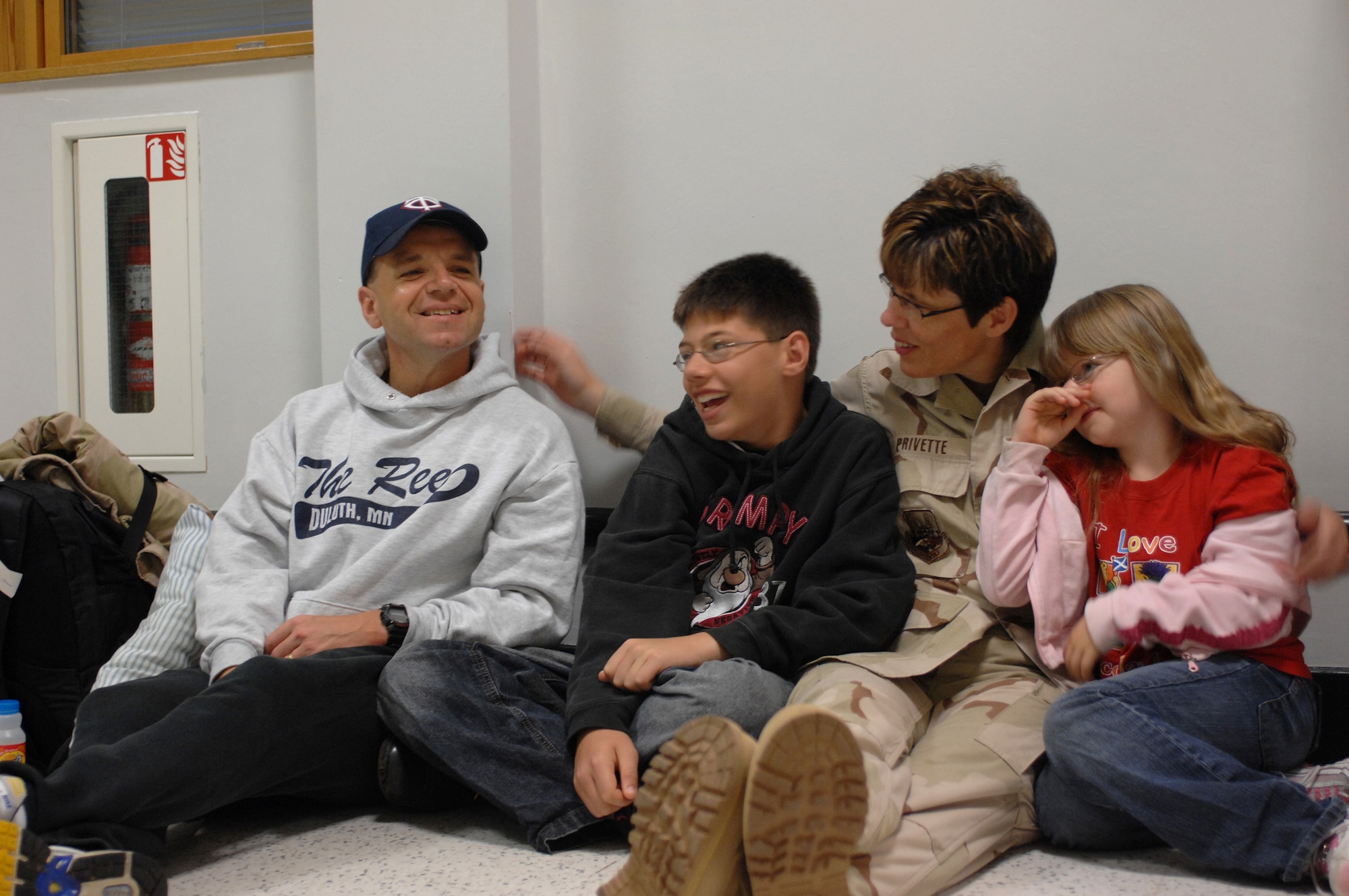 Master Sgt. Julie Privette, from the 100th Services Squadron, jokes with her husband, Master Sgt. Derek Privette, 352nd Operations Support Squadron Security Forces, son Matthew, 12, and daughter Rachel, 8, prior to her deployment from RAF Mildenhall, Sept. 14, 2007. (U.S. Air Force photo by Tech. Sgt. Tracy L. DeMarco)
