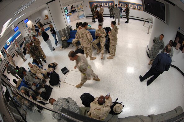 Airmen wait in the passenger terminal at RAF Mildenhall prior to boarding an Air Mobility Command aircraft, set to transport them to various deployment locations Sept. 14, 2007. (U.S. Air Force photo by Tech. Sgt. Tracy L. DeMarco)
