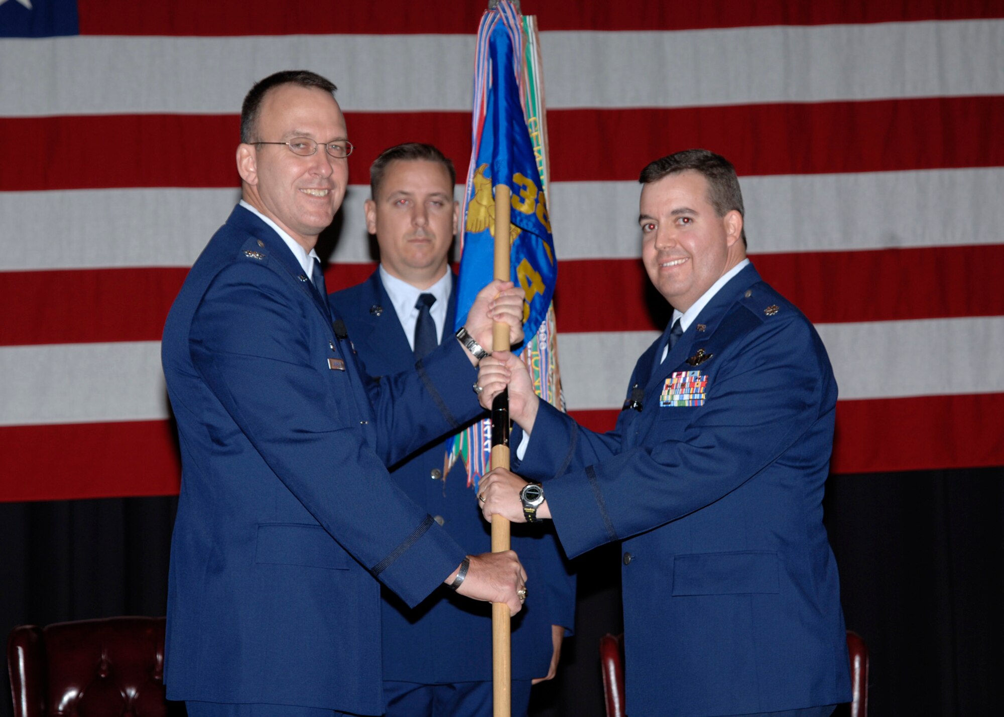 MCCONNELL AIR FORCE BASE Kan-Colonel Ray E. LaMarche left, 22nd Mission Support Group commander, hands the 384th Air Refueling Squadron guideon to Lt. Col. Eric D. Casler, Sept. 12 during an assumption of command ceremony here. Lt. Col. Casler succeeded Lt. Col. William Knight as commander of the 38th ARS. (photo by Airman 1st Class Roy Lynch III) 