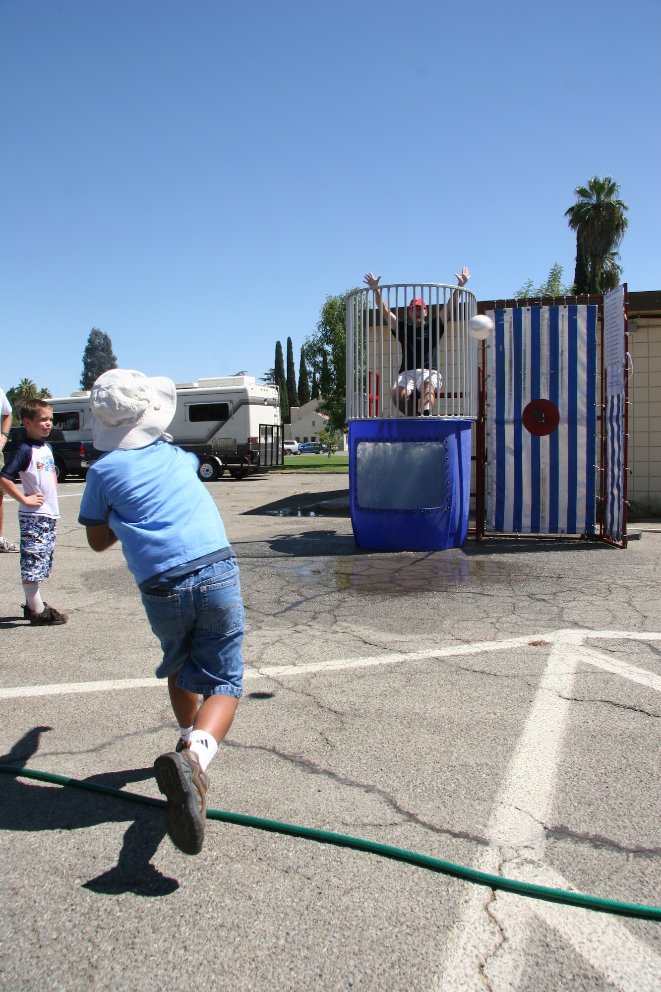 Col. Albert Aimar, 163rd Reconnaissance Wing Commander, takes a splash in the dunk tank. March Field leadership took turns giving guests the opportunity to get them wet.  (U.S. Air Force photo by Senior Airman Paul Duquette)